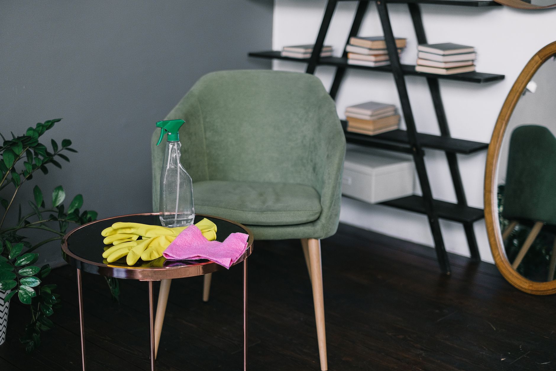 Cleaning products, microfibre cloths, and spray bottles arranged neatly on a table