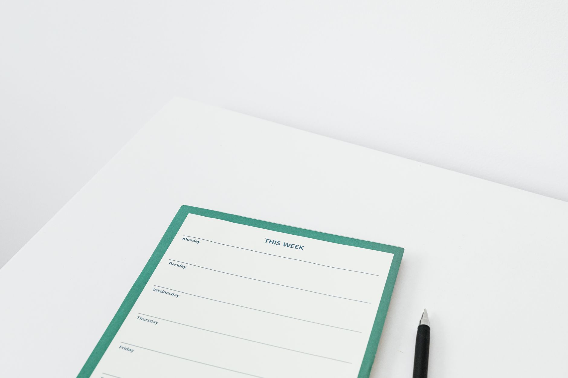 A weekly planner and calendar on a desk, mapping out the first ninety days of cleaning work