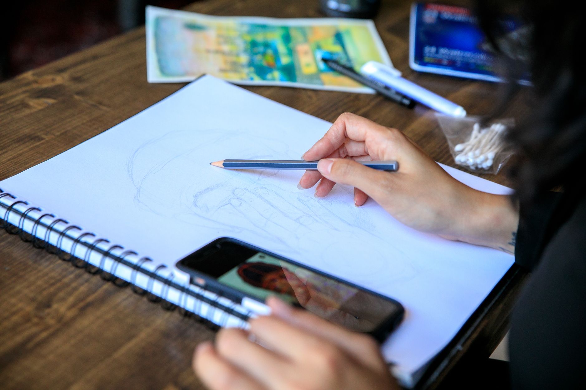 An illustrator checking engagement on their newsletter over coffee