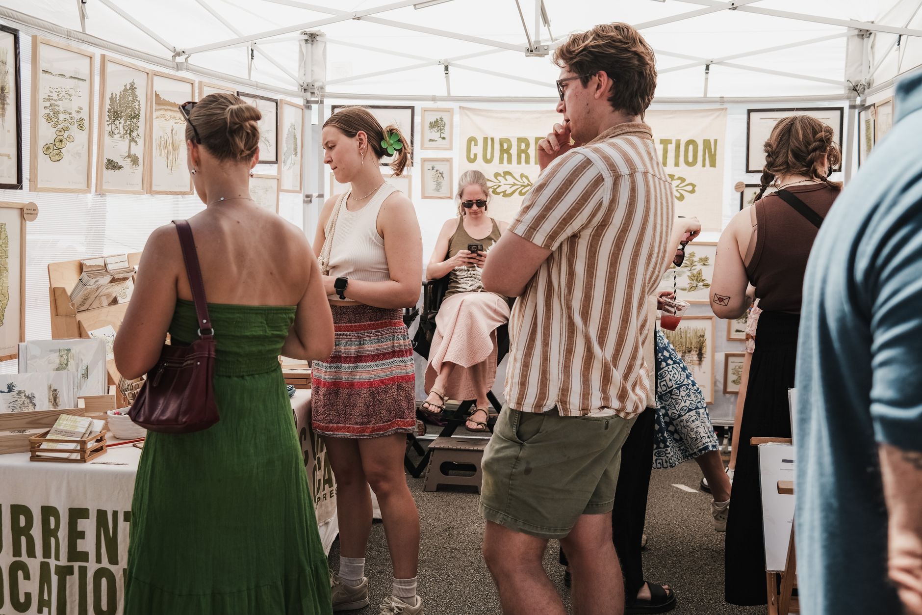 A maker collecting a genuine newsletter sign-up at a market stall
