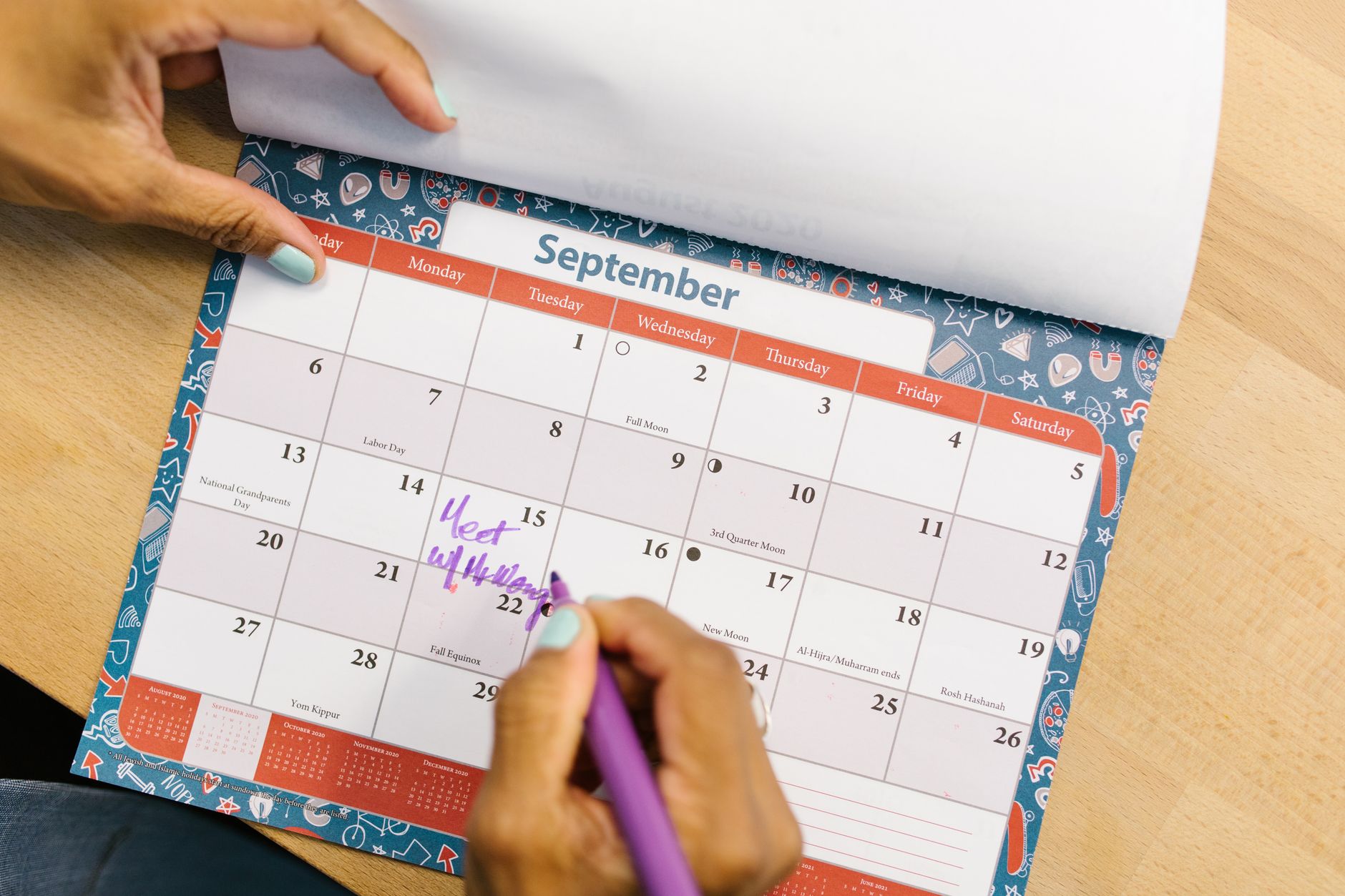 A maker marking their monthly newsletter date on a calendar