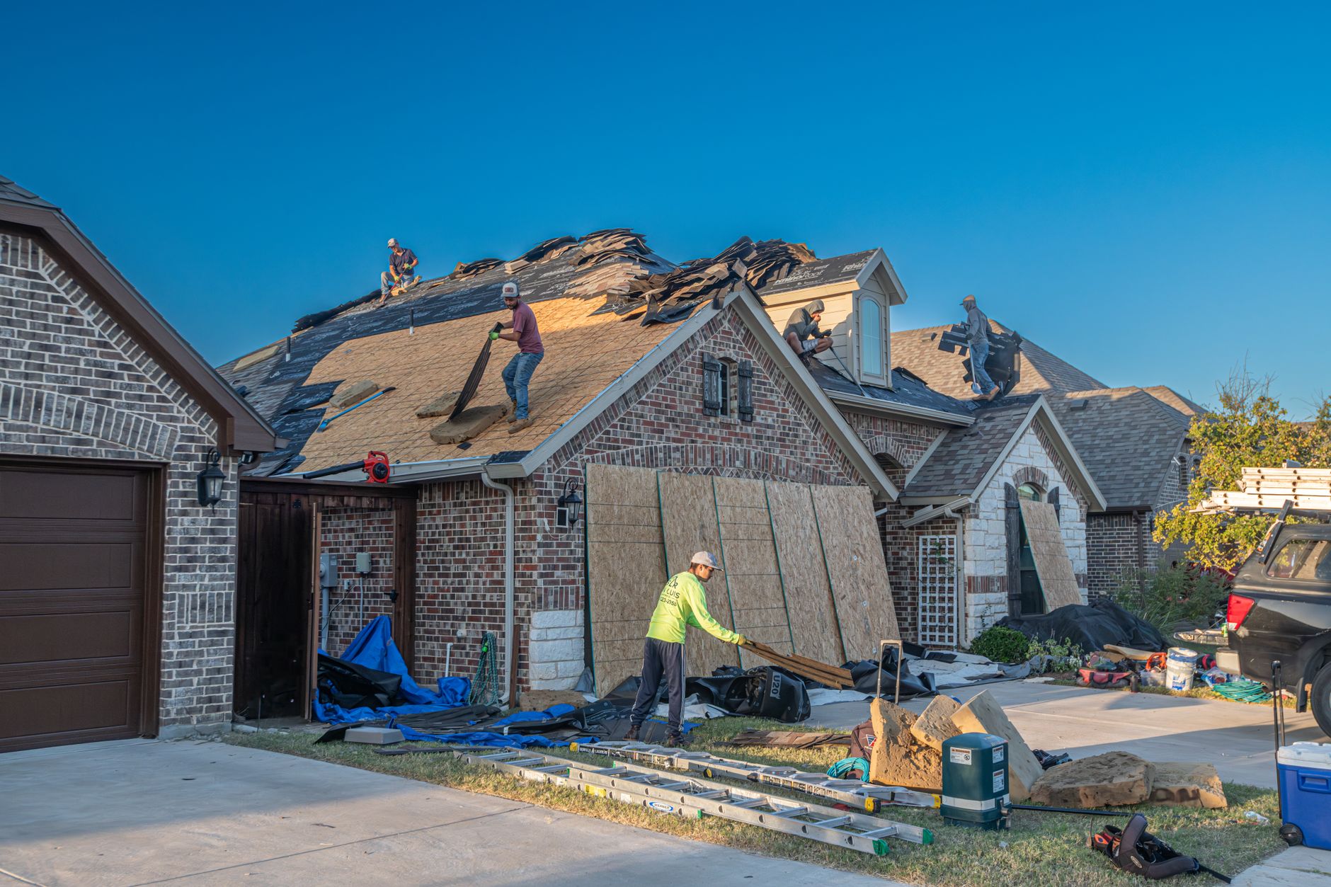 A roofer discussing a repair with a homeowner who contacted them directly