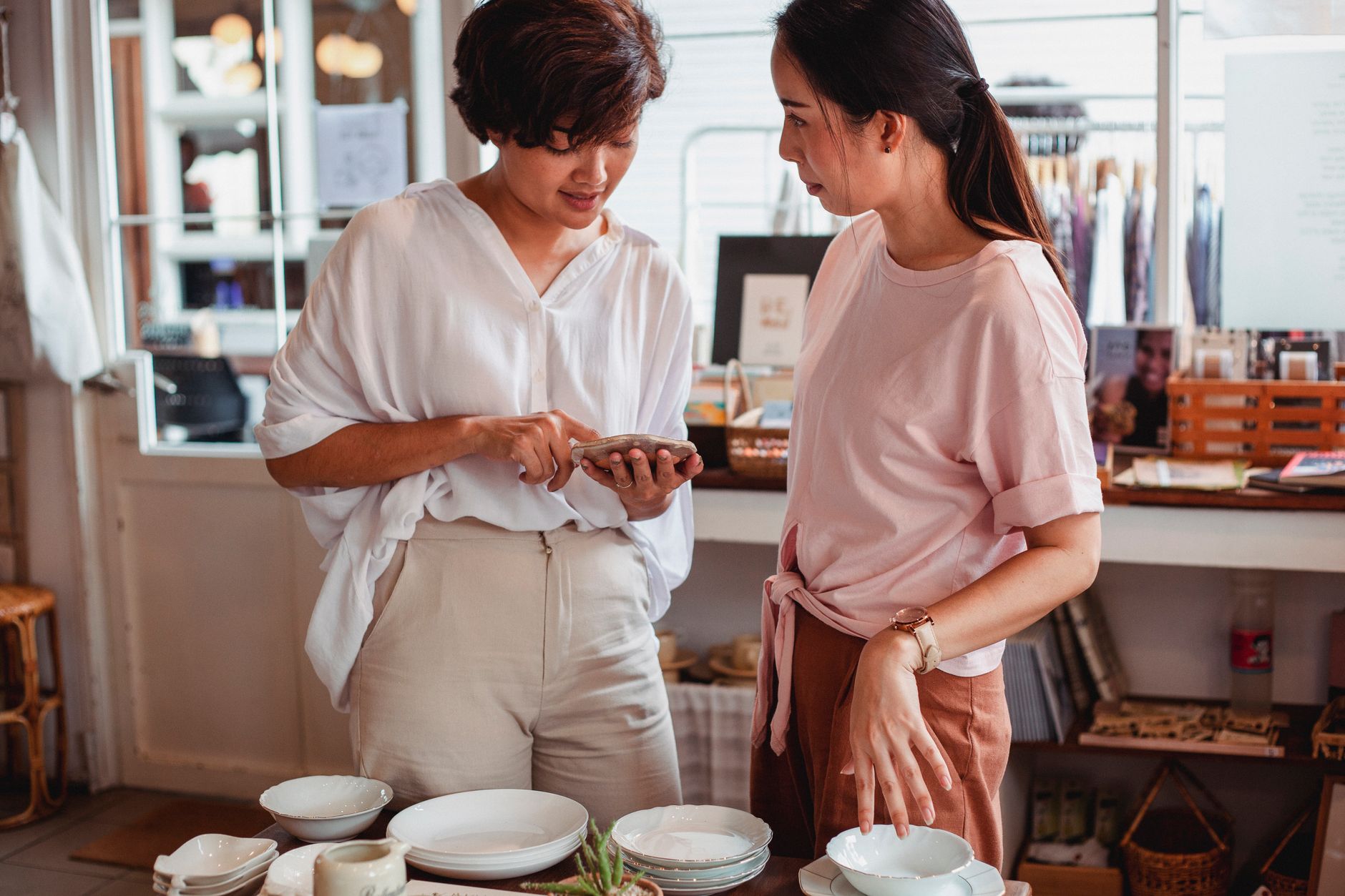Two customers weighing up local businesses before deciding
