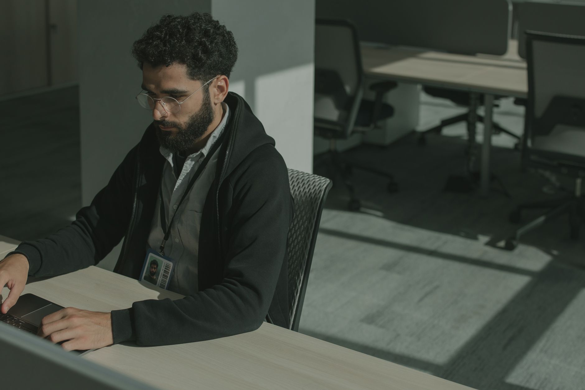 A software company founder writing a LinkedIn post at their desk