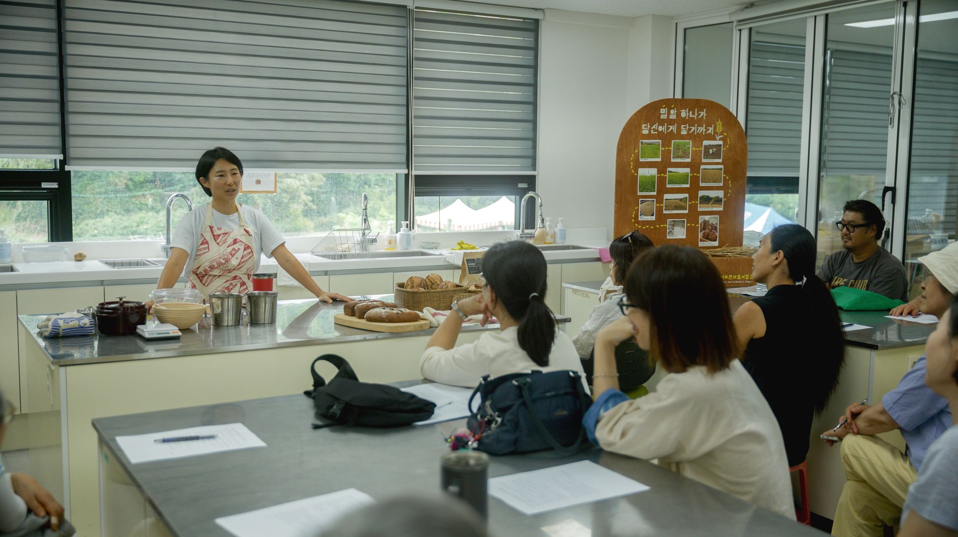 A bakery owner running a community baking class with a local resident