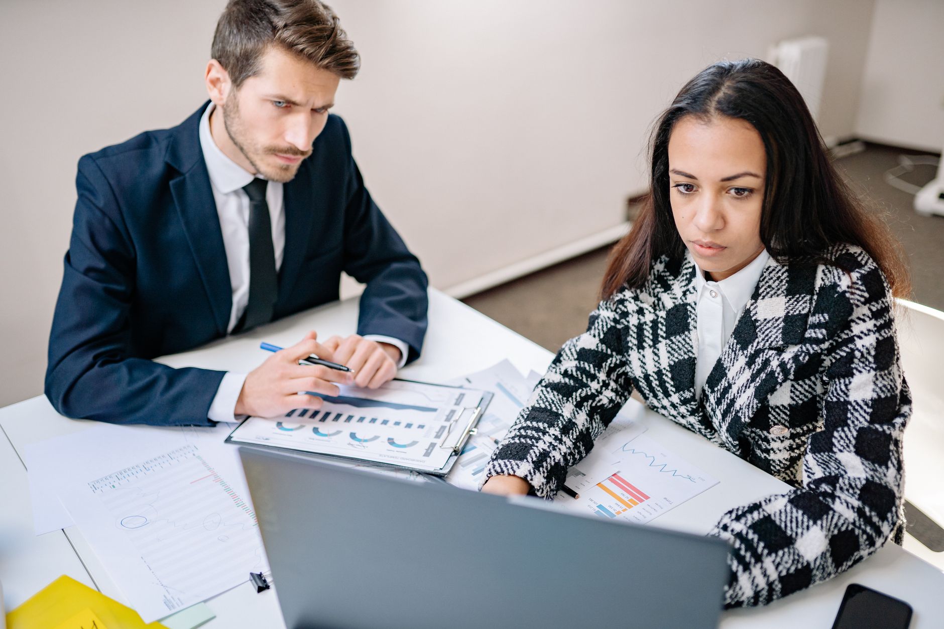 Two colleagues comparing published data against their own customer notes
