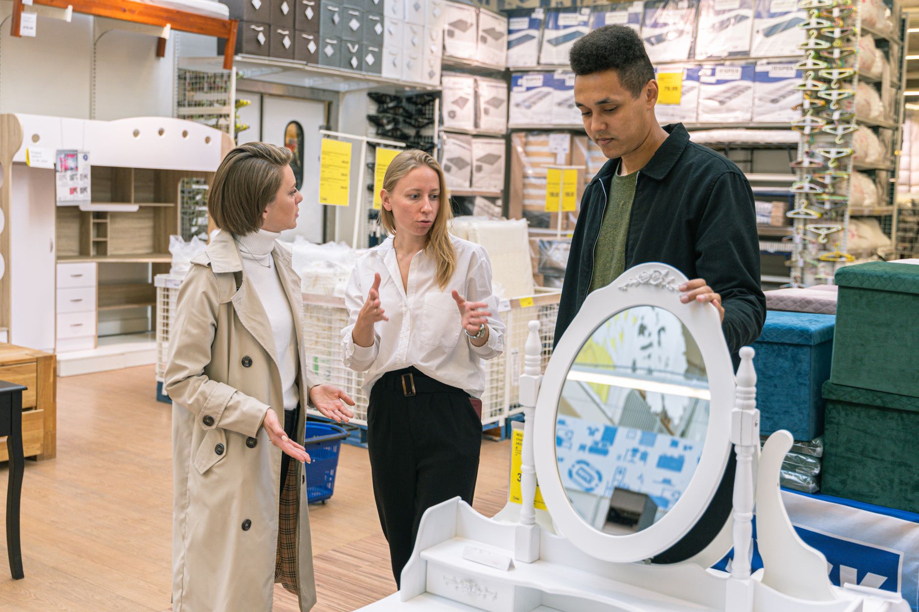 A homeware shop assistant serving a returning customer