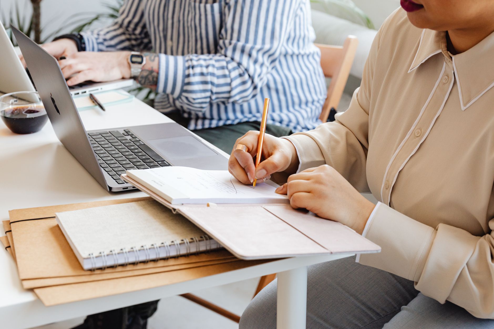 Two colleagues comparing a strategy document with a dated calendar