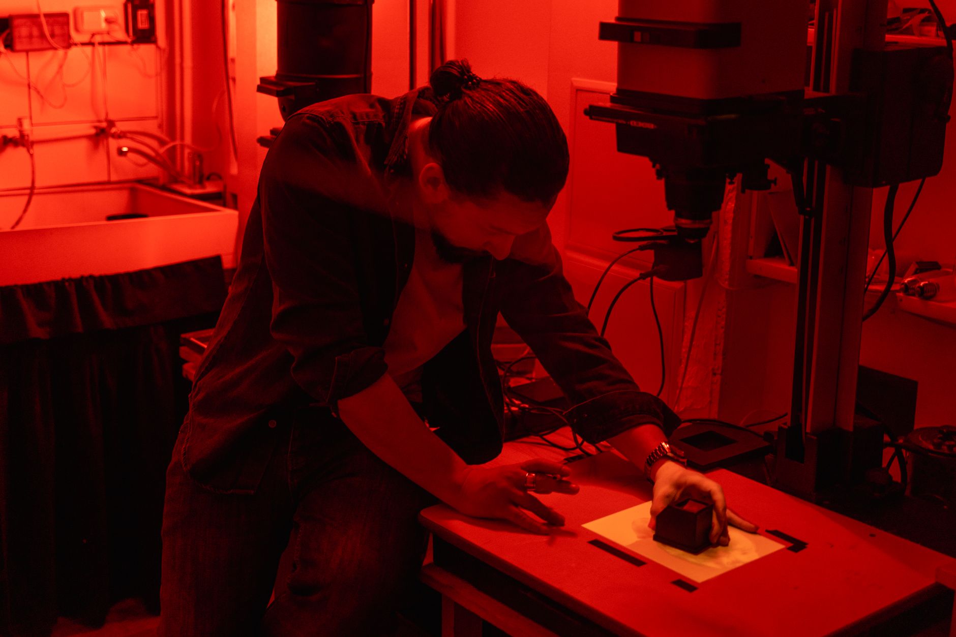 A printmaker photographing finished work for social media