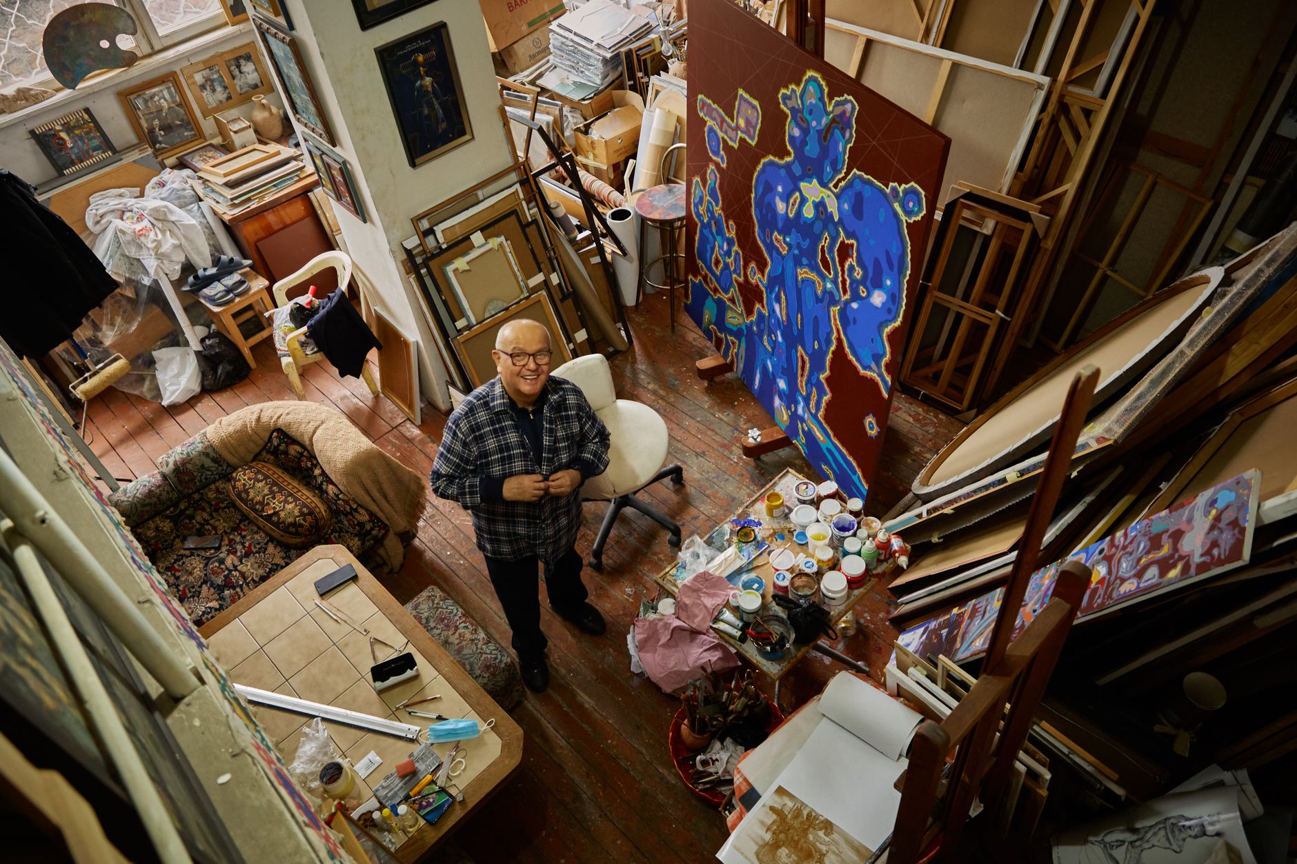 A painter surrounded by a consistent body of finished work