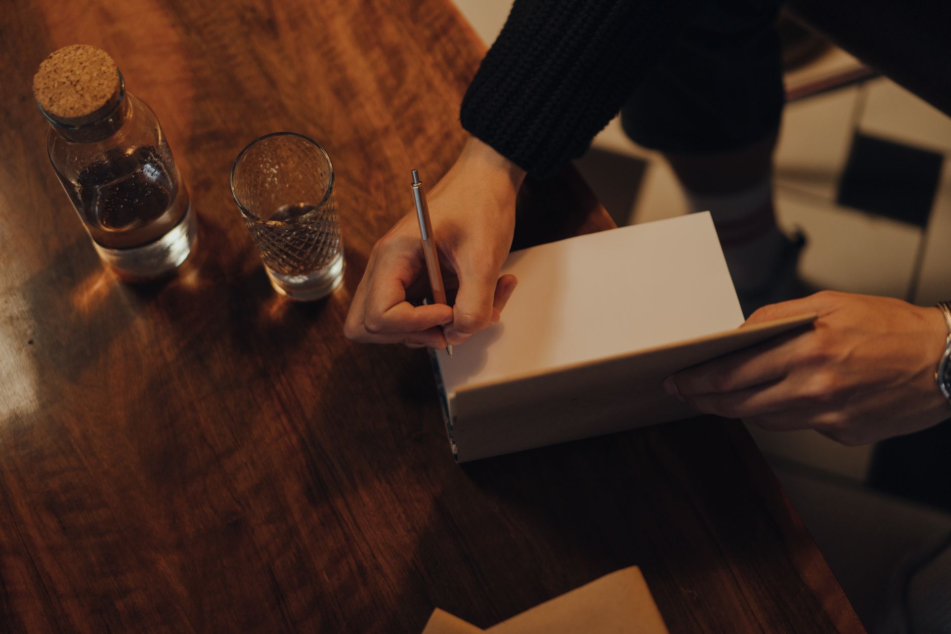 An author preparing signed copies of their book to send to readers