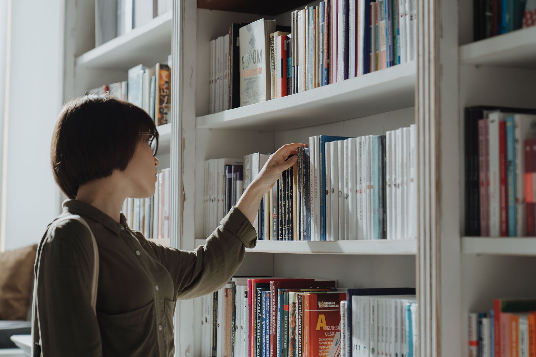 A reader browsing fiction titles in a bookshop