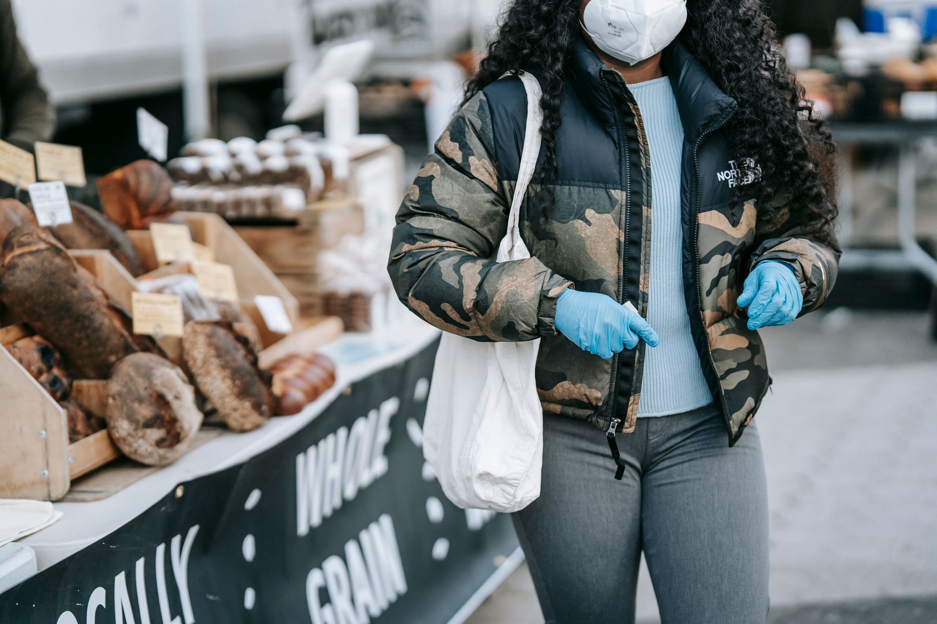 A customer weighing up a purchase outside a local bakery