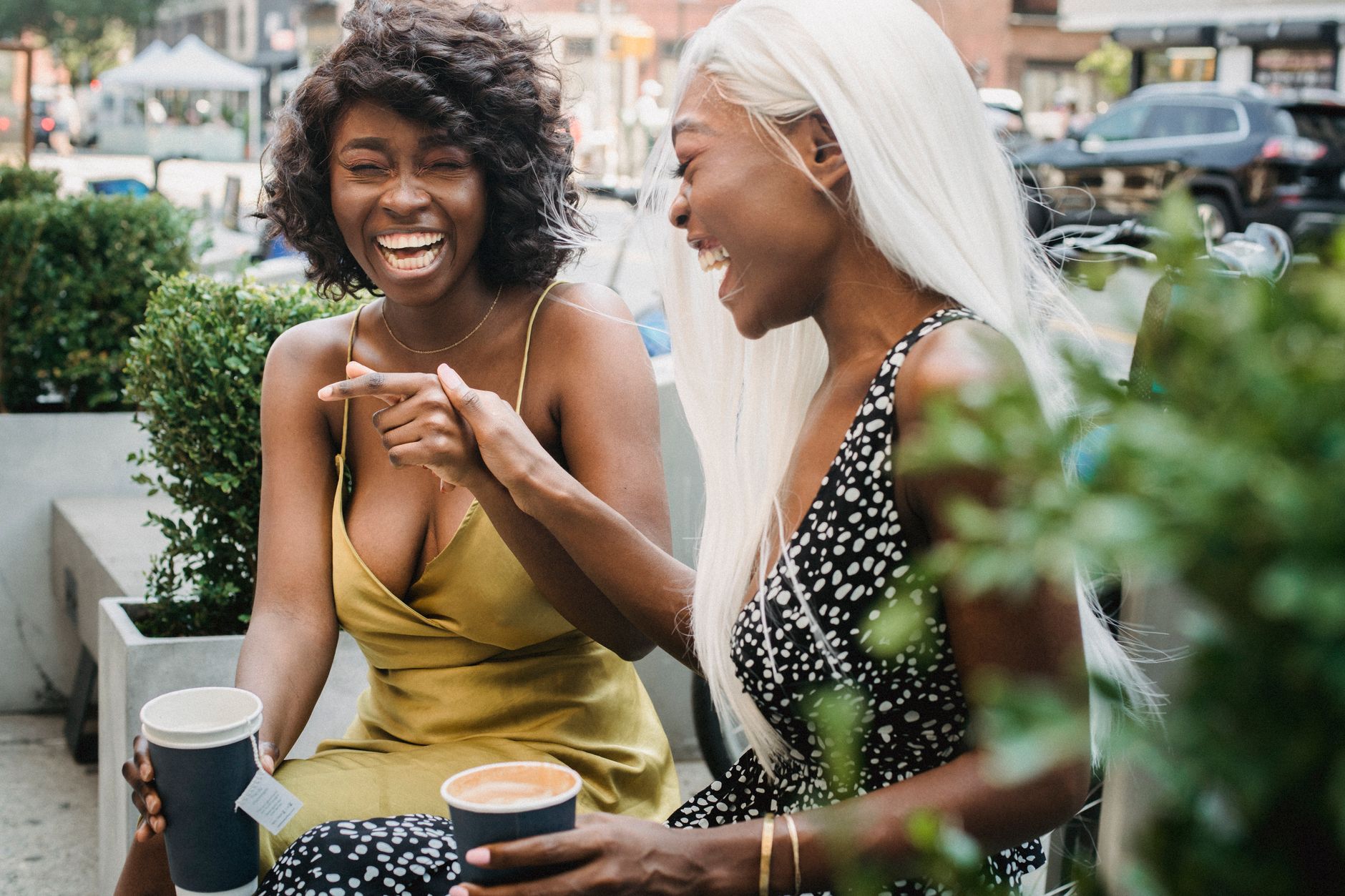 Two friends enjoying a bakery treat together outside
