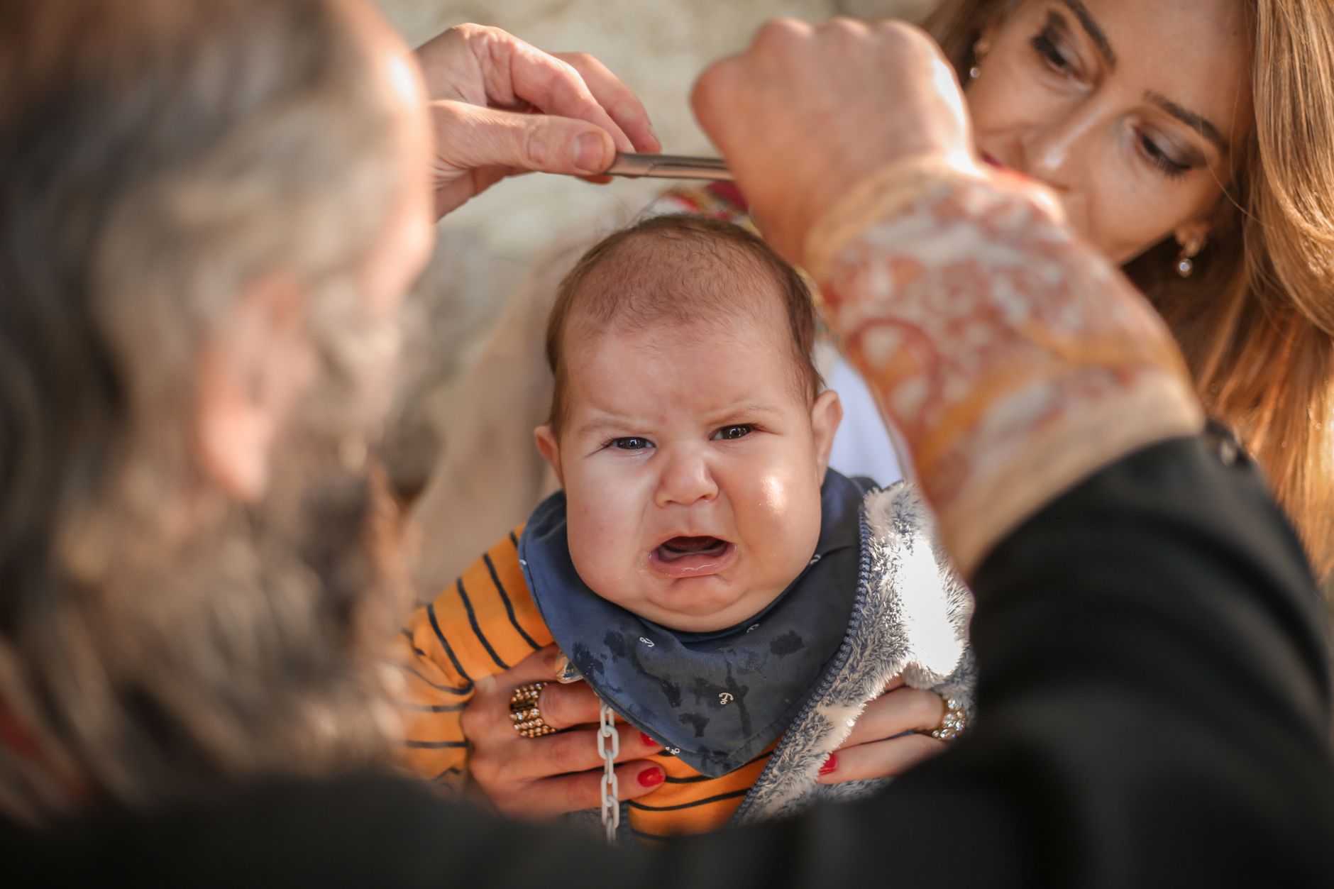 A barber giving a nervous child their first proper haircut