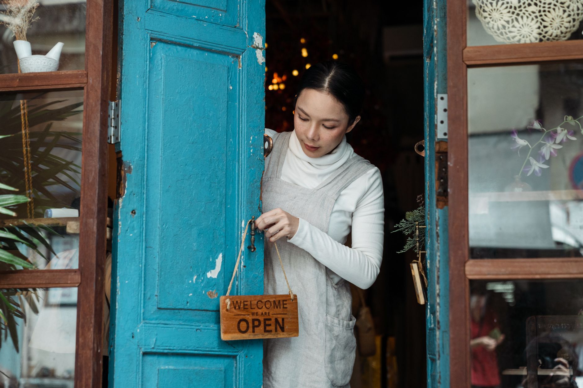 A small salon owner opening up for the day
