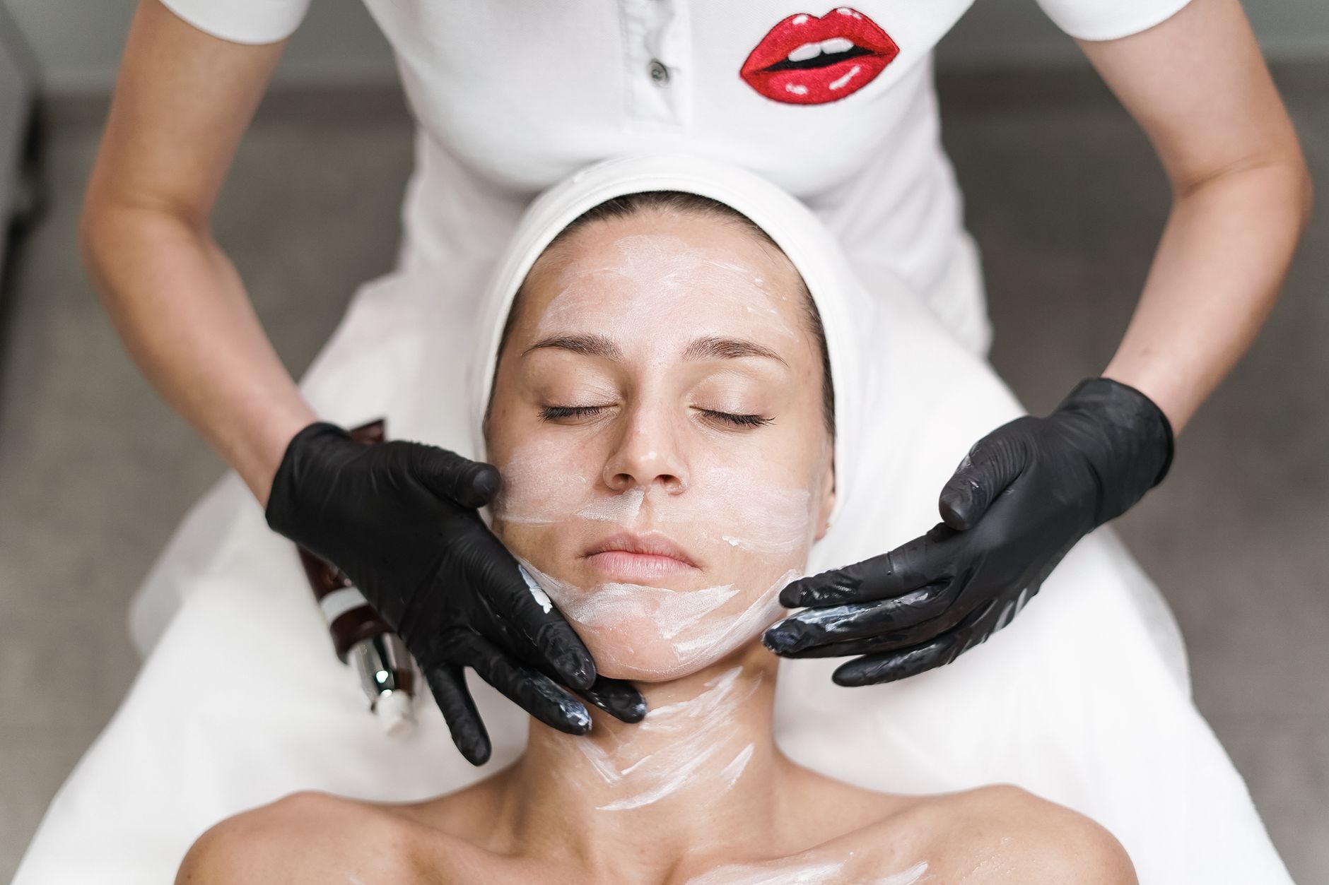 A beautician photographing a client's finished look for social media