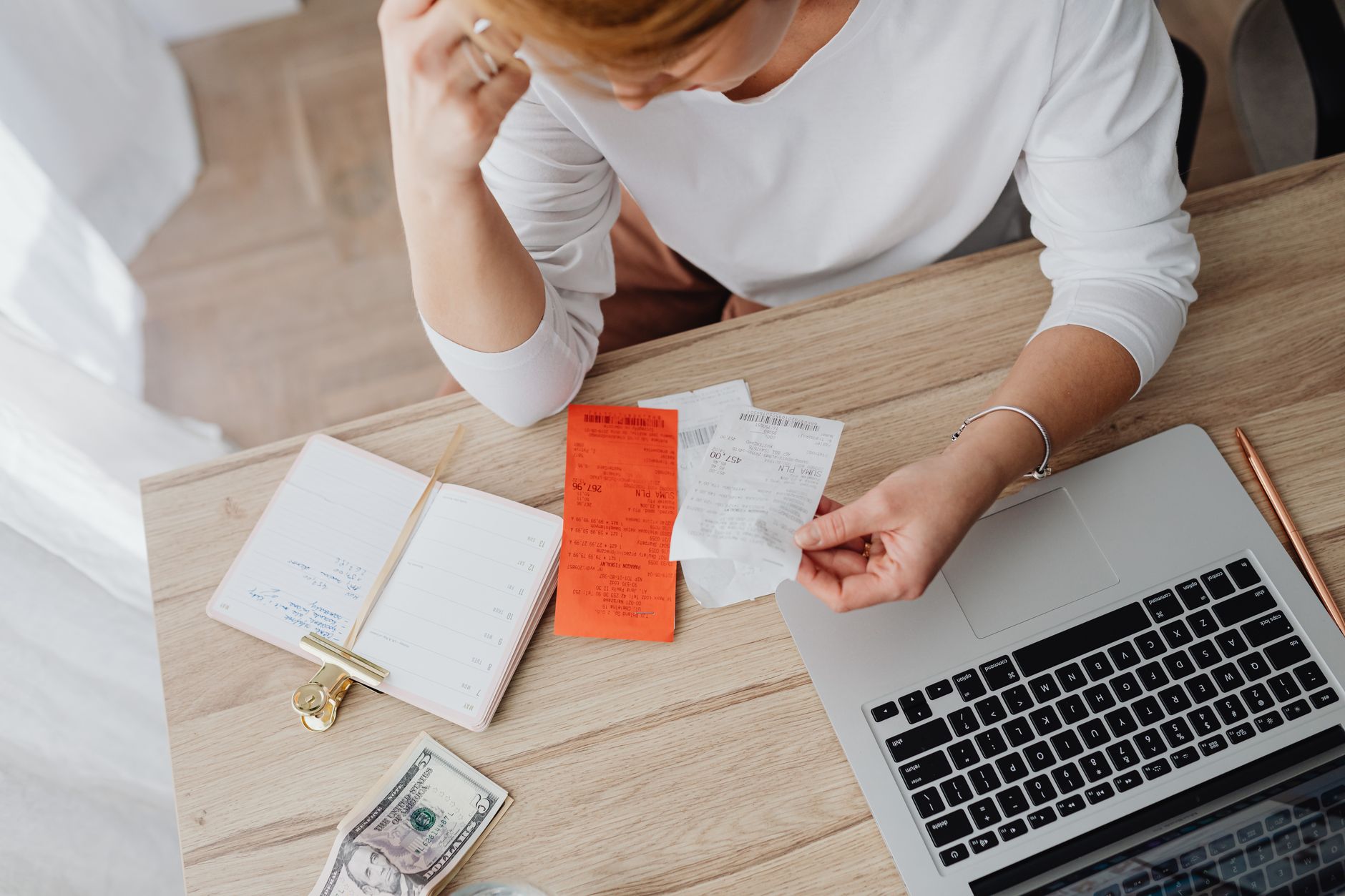 A salon owner reviewing costs and takings at her desk