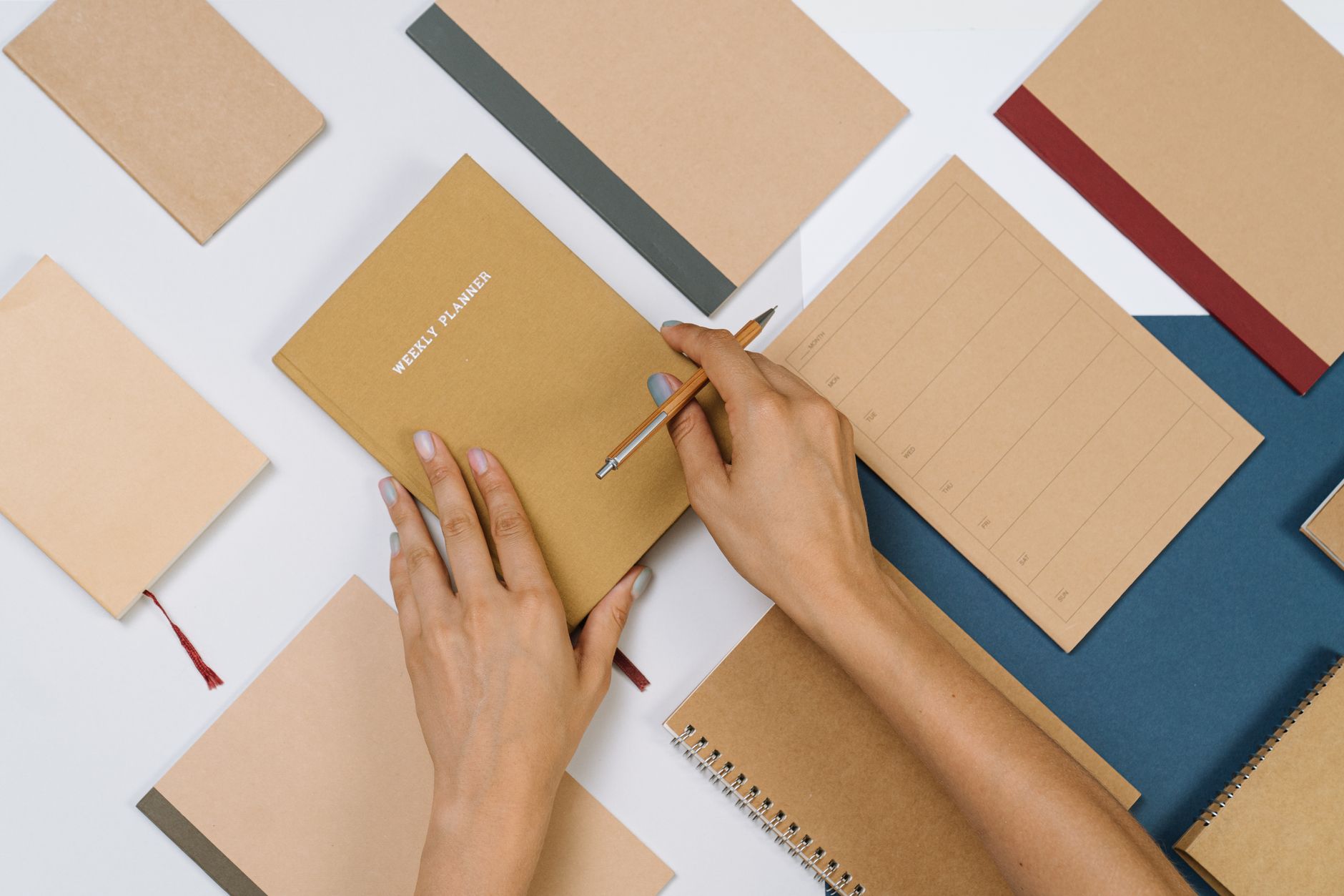 A beautician planning her week's marketing tasks in a notebook