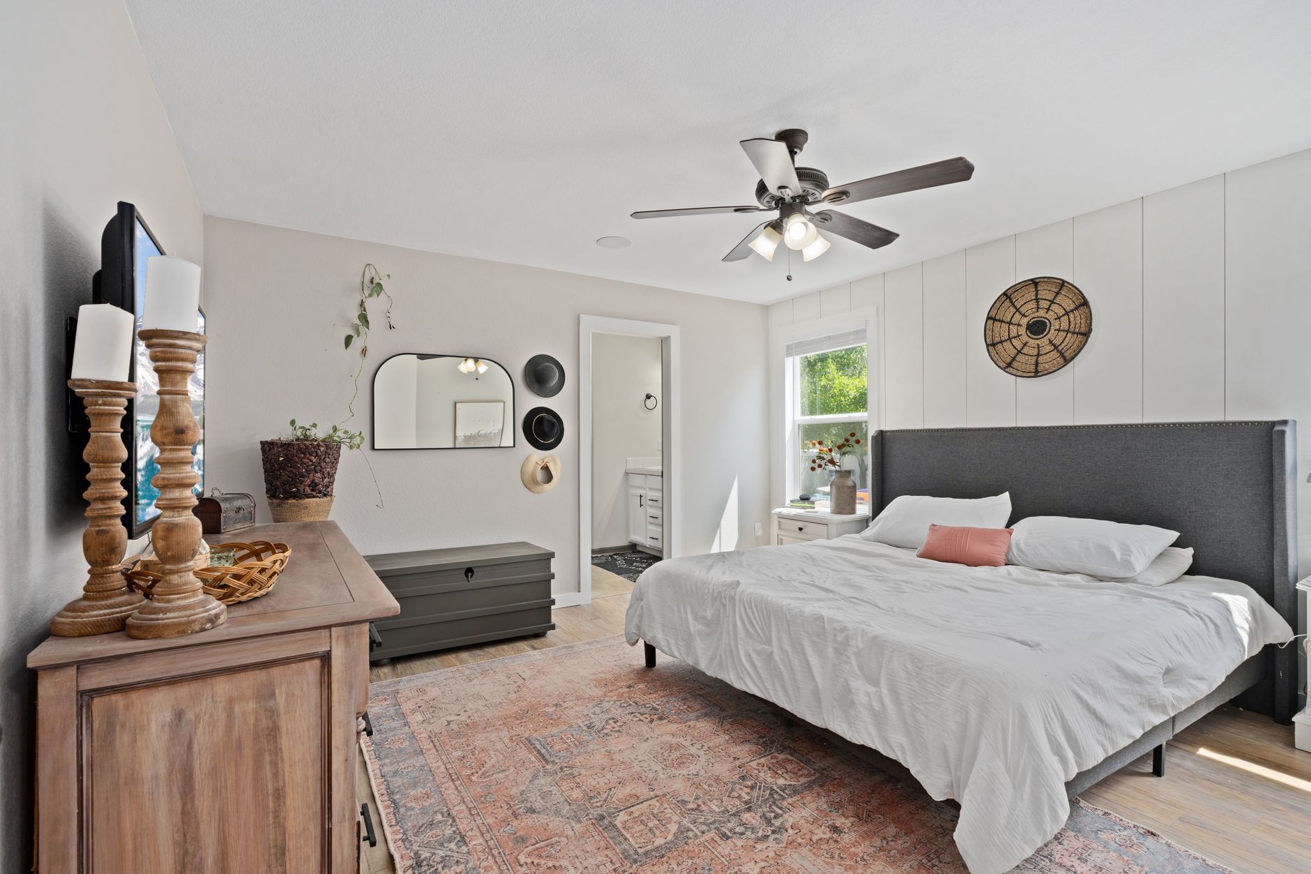 A guest house owner photographing a room for their online listing