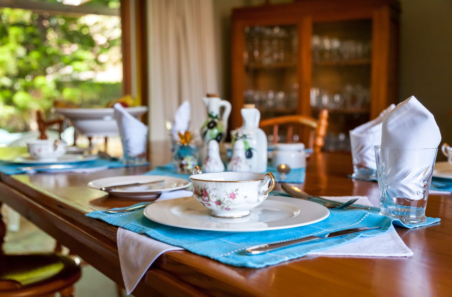 A host serving a home-cooked breakfast to guests at their B&B