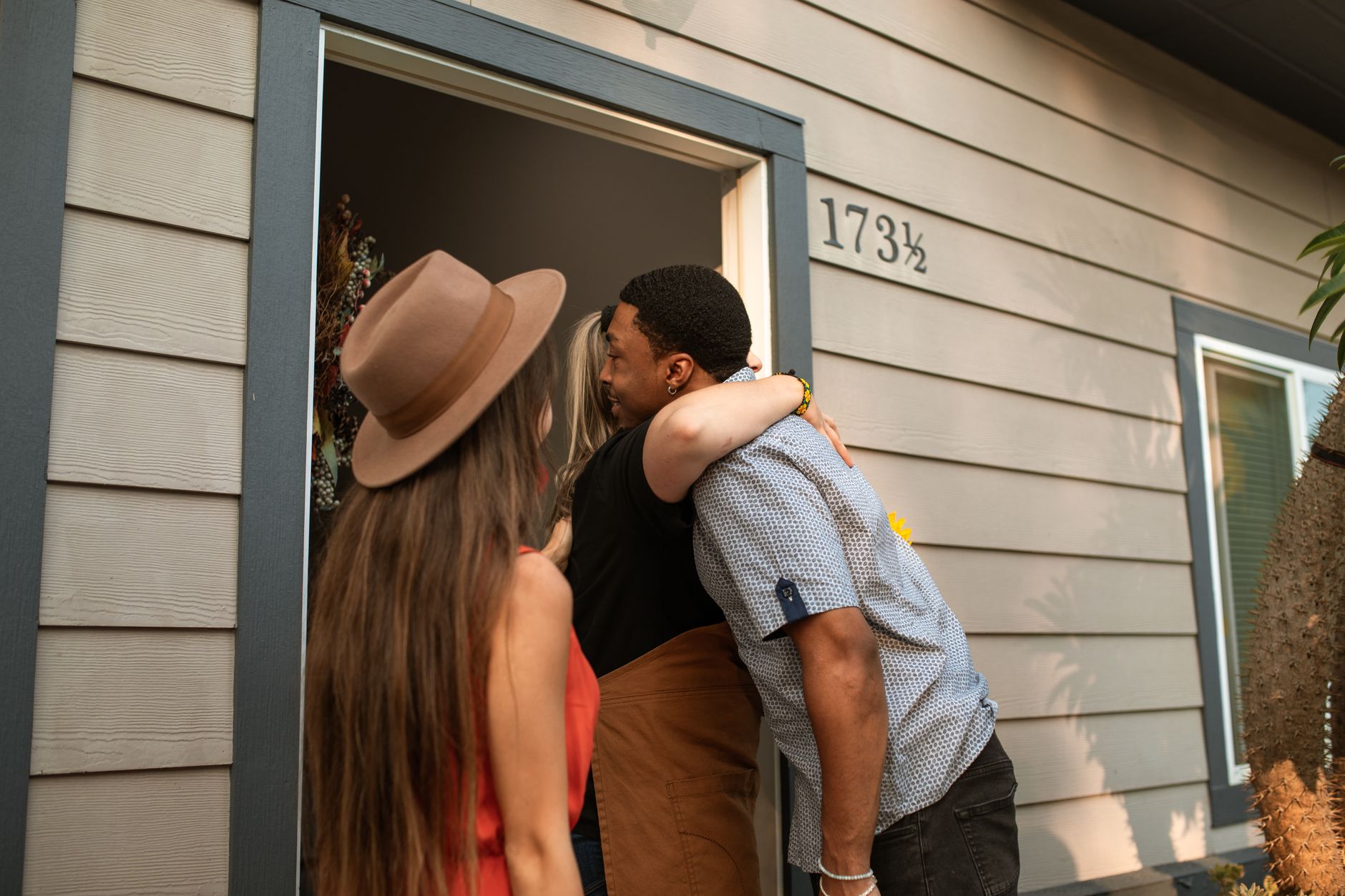 A bed and breakfast owner greeting an arriving guest at the door