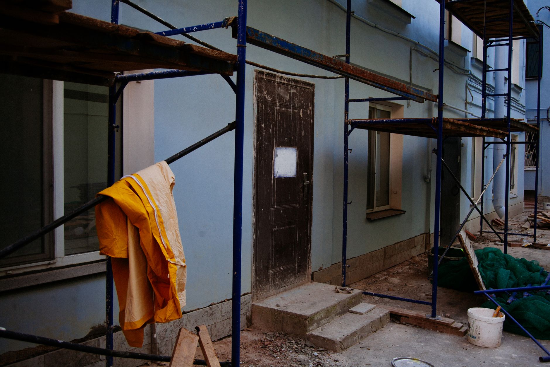A branded site board outside a house mid-renovation