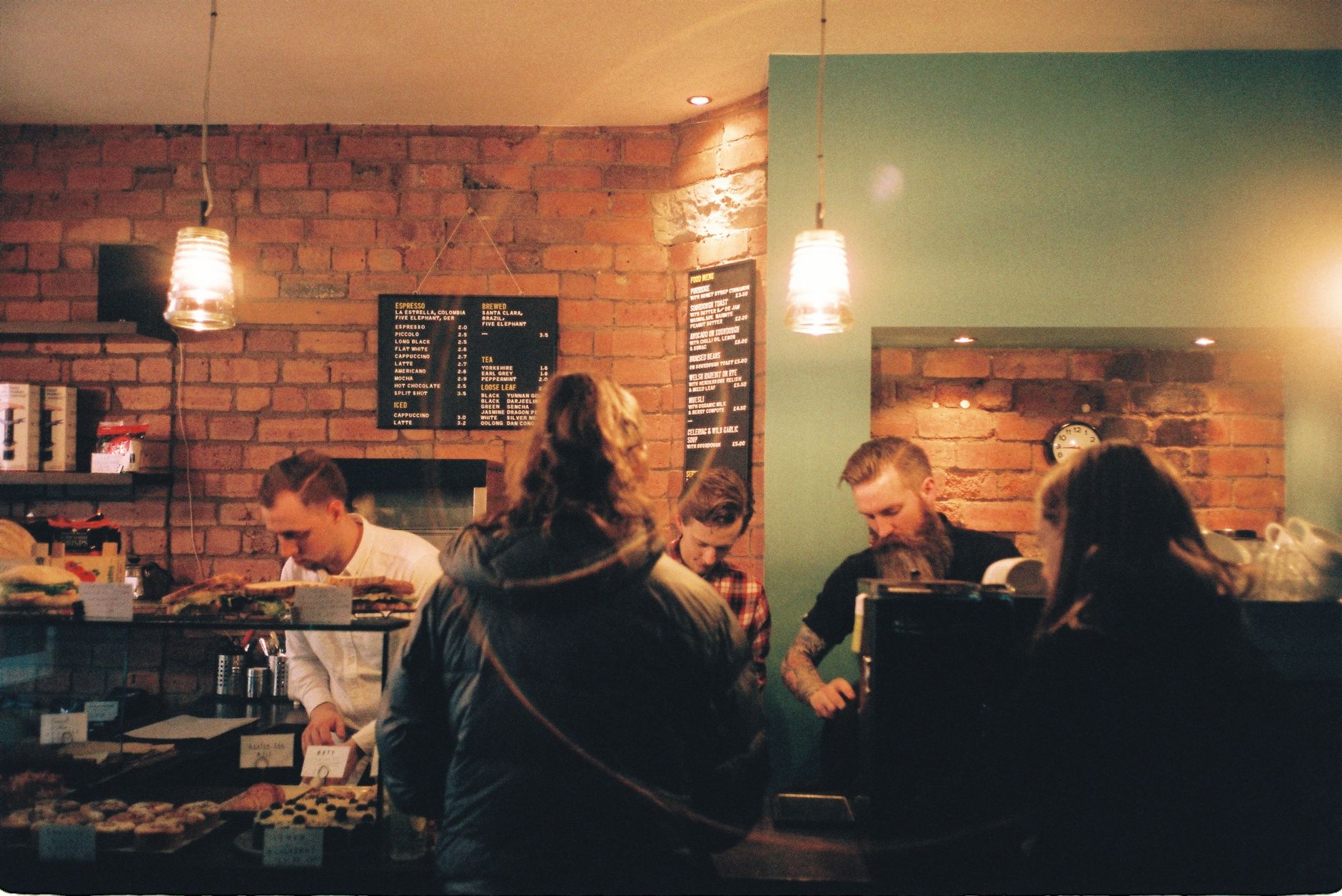 Customers queuing outside a popular independent cafe in the morning