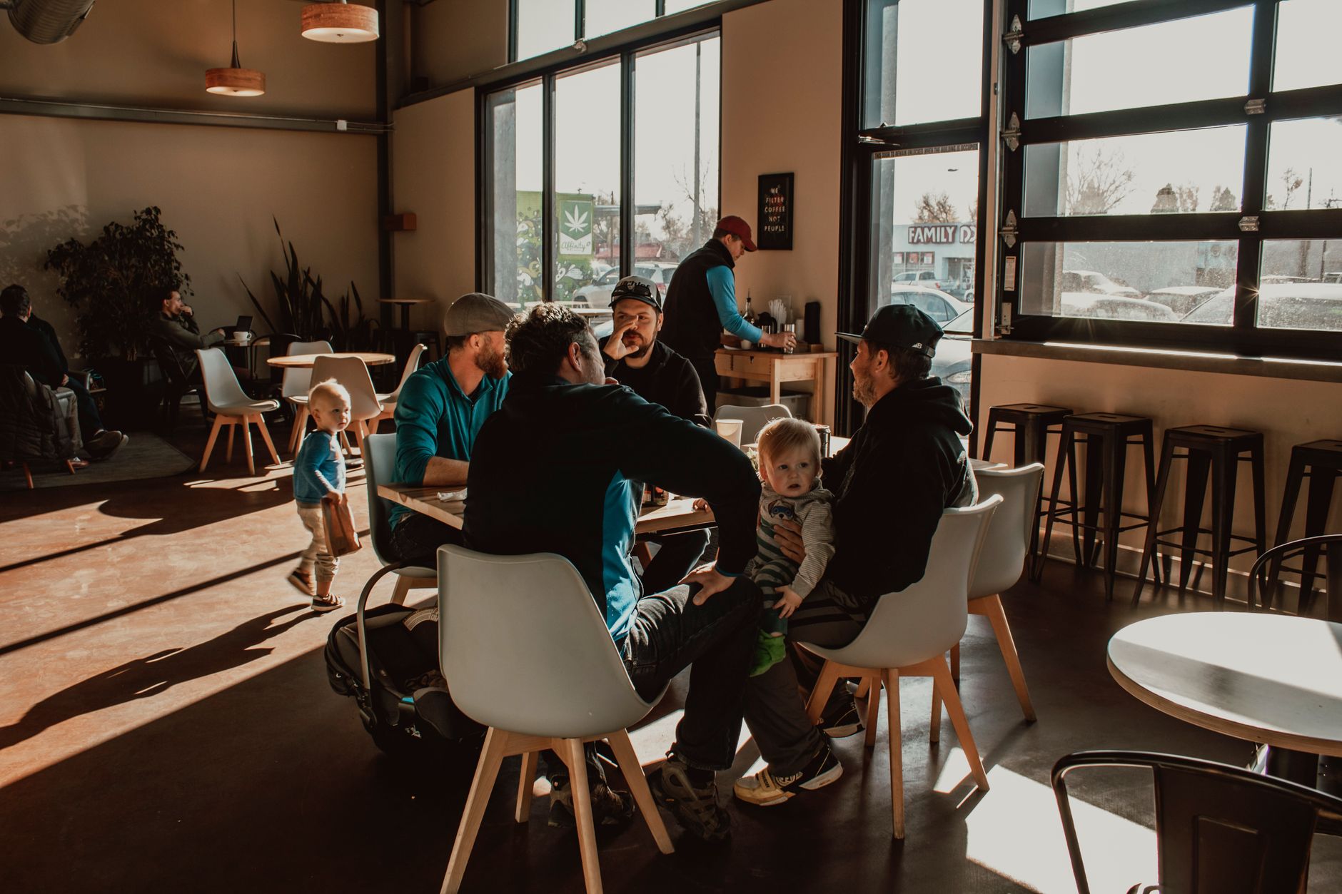 Parents meeting for coffee with pushchairs in a welcoming cafe