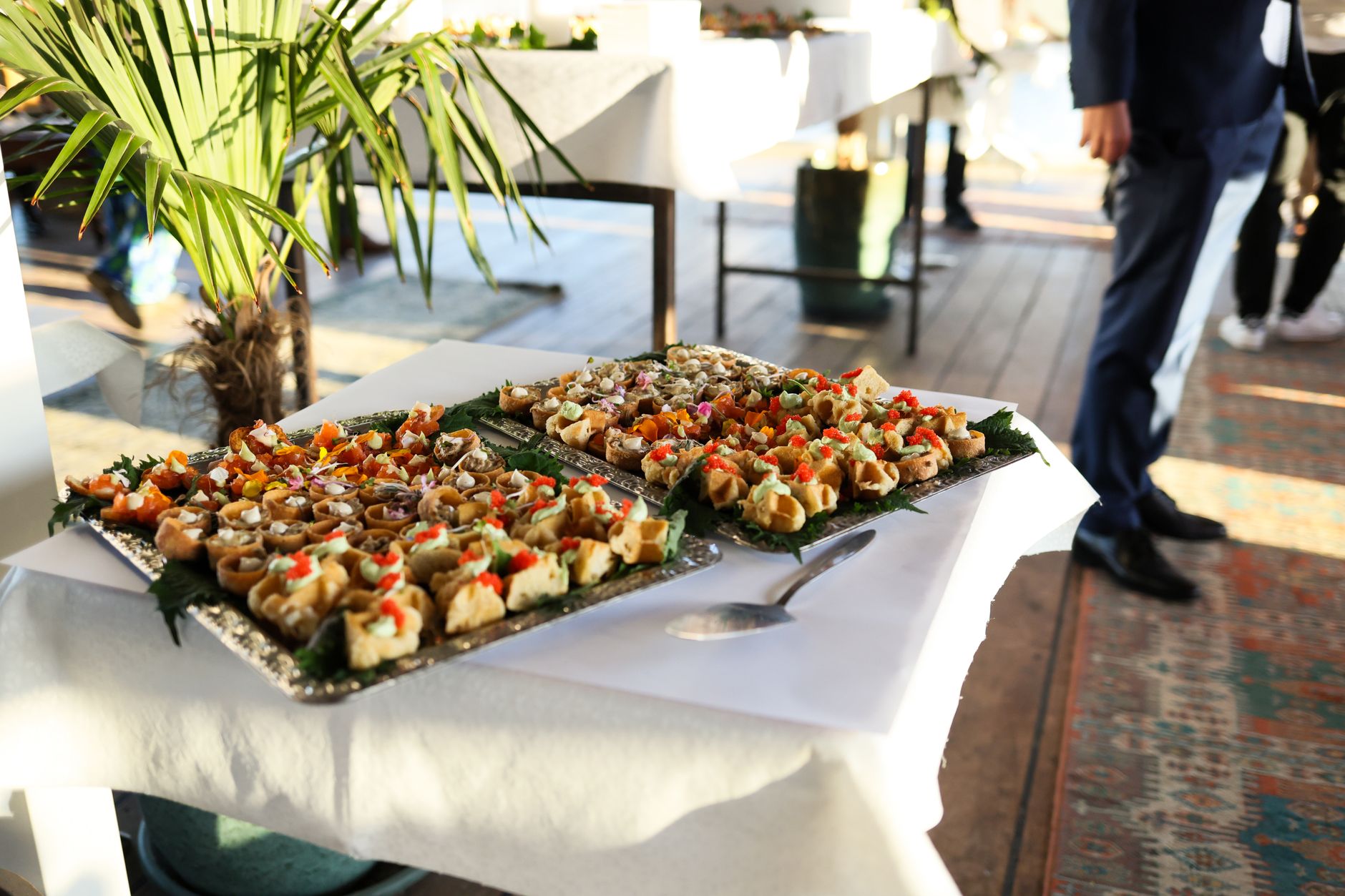 A caterer photographing a finished buffet before guests arrive