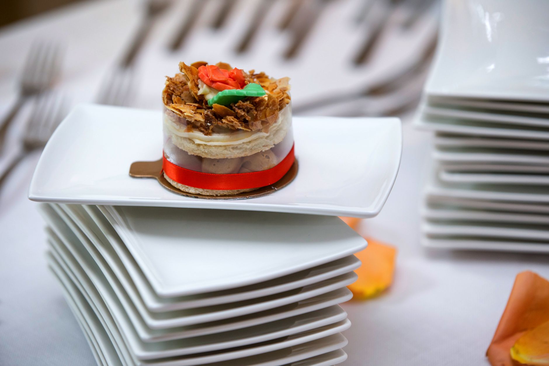 A chef plating a dessert course for a wedding reception
