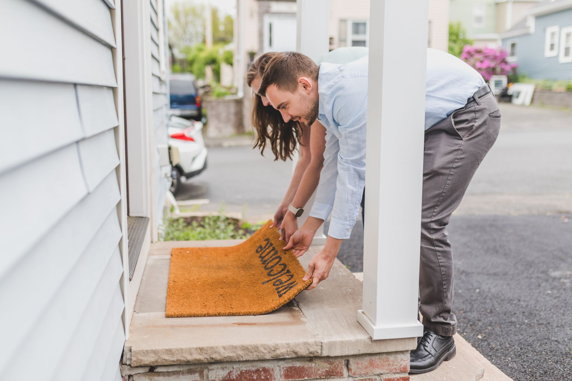An electrician handing over completed work to a homeowner at the door