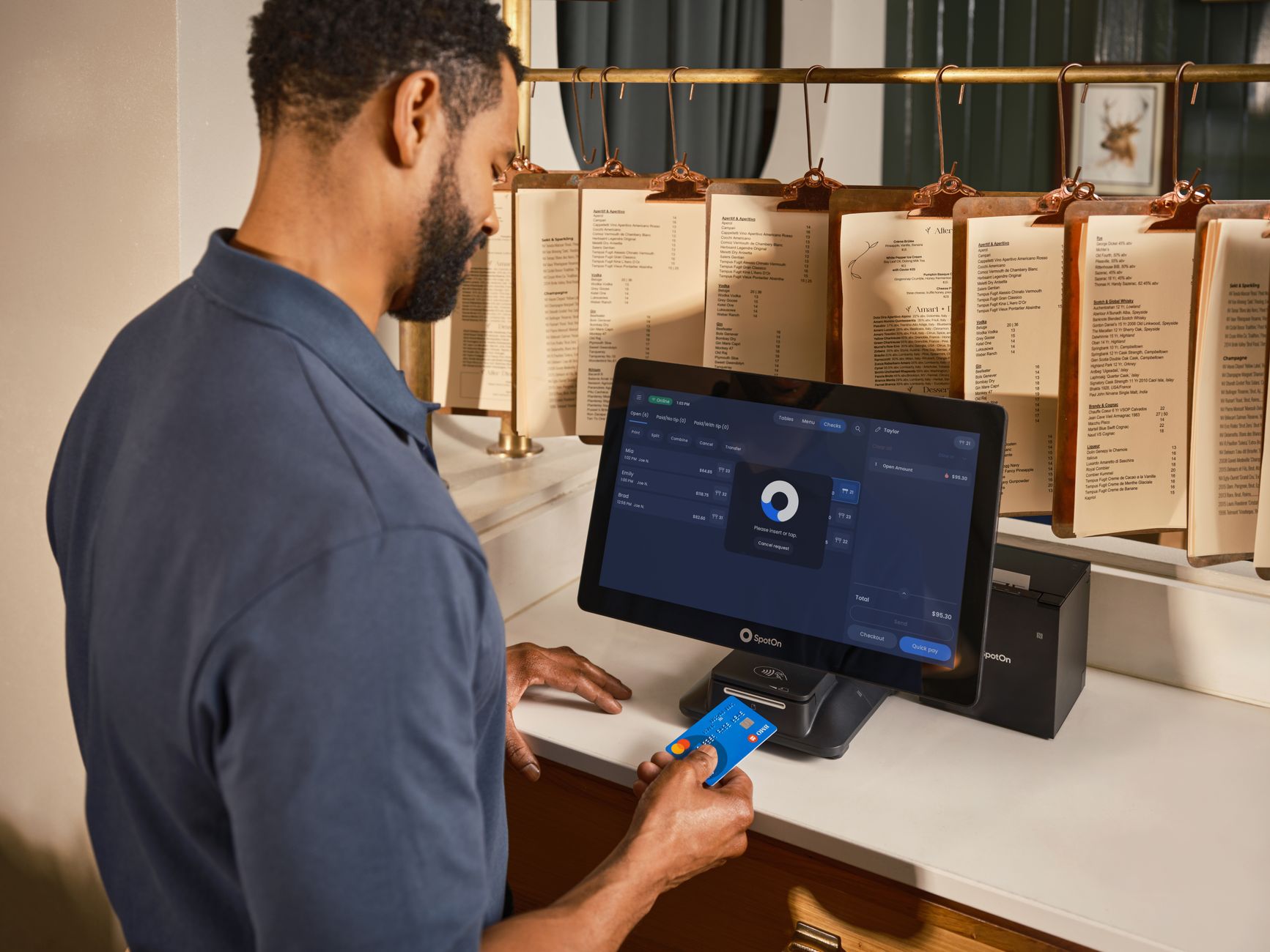 A staff member checking in a returning gym member