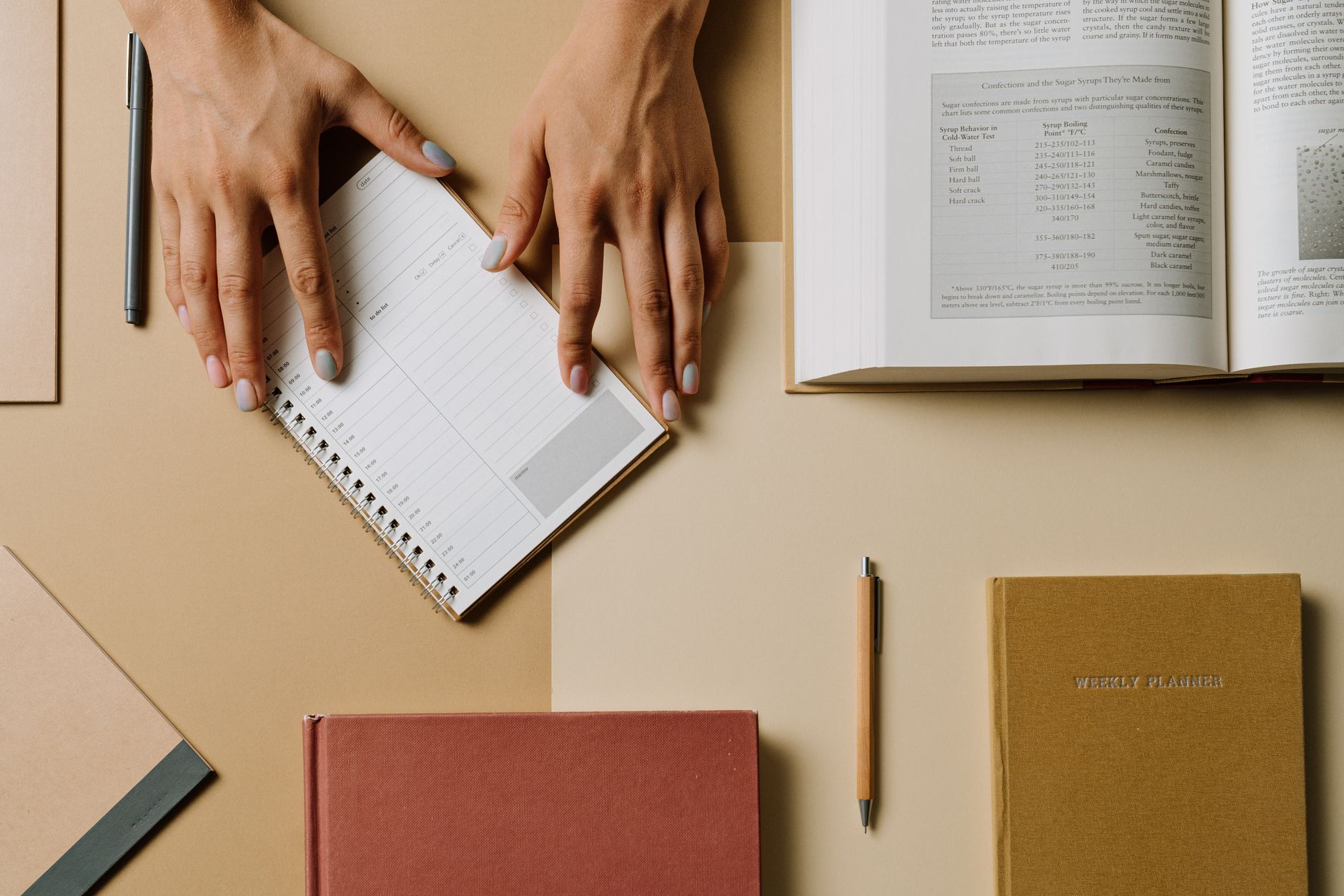 An illustrator planning their marketing steps in a notebook