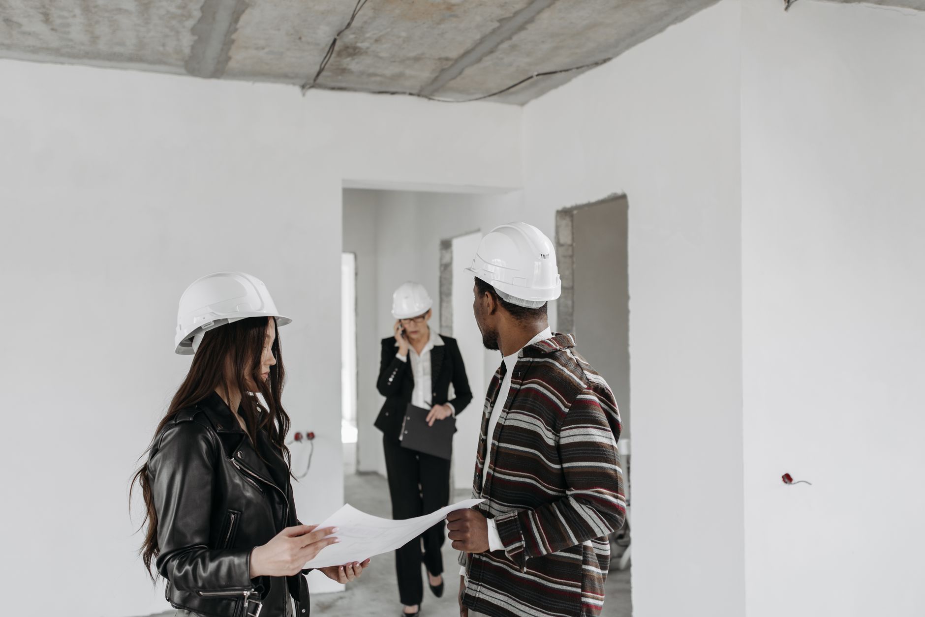 A designer coordinating with a builder on a renovation site