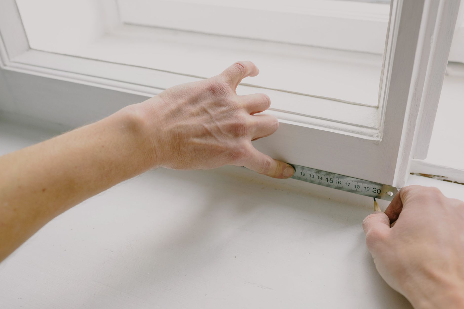 A designer taking measurements in a period property