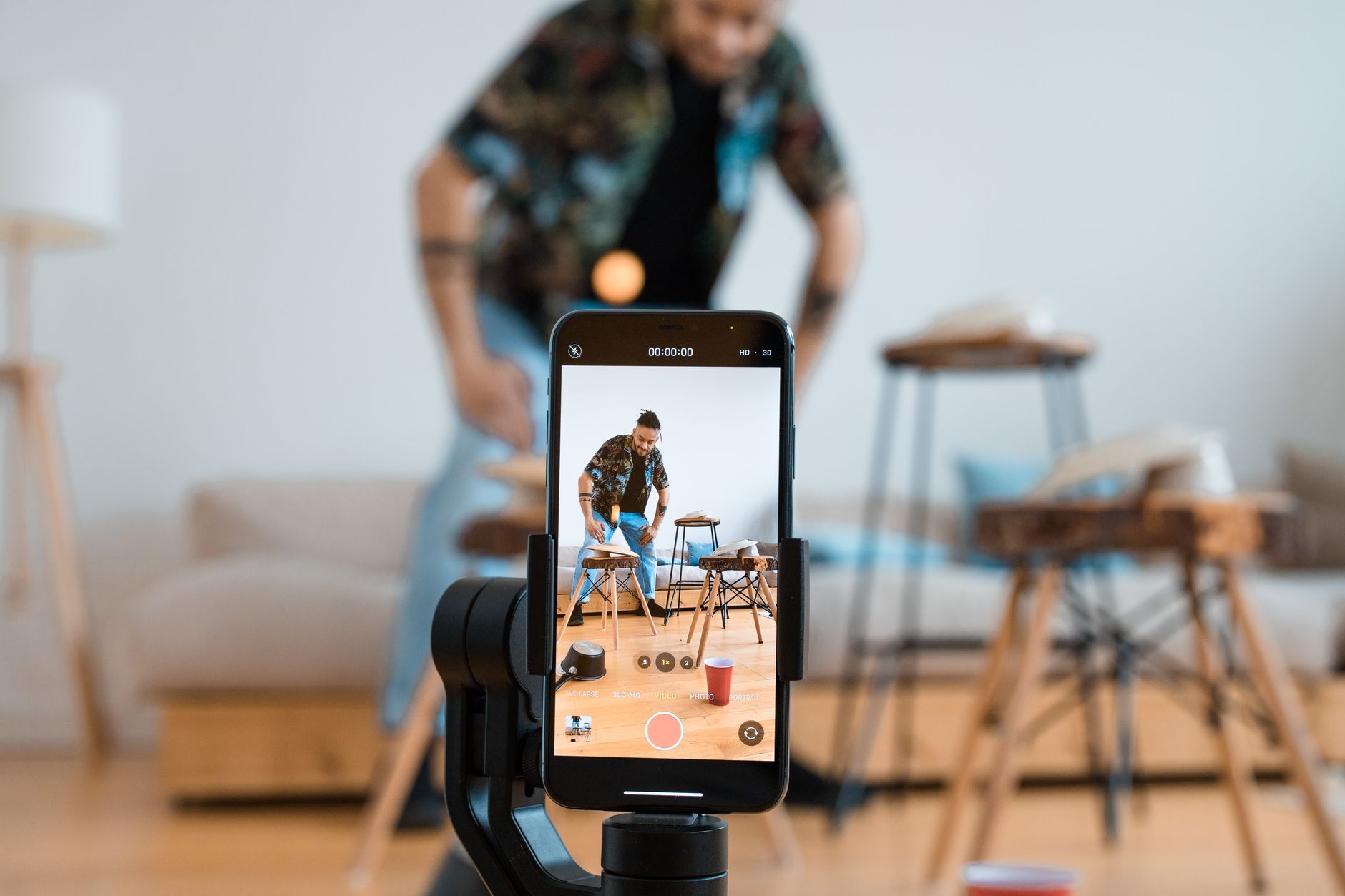 A designer recording a room reveal video for social media