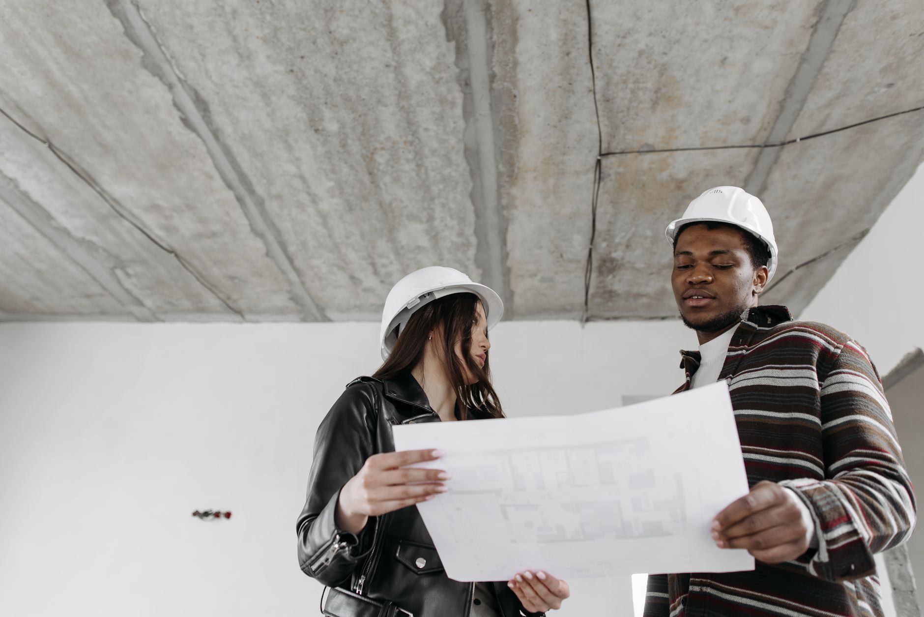 A designer and an architect greeting each other on a project site