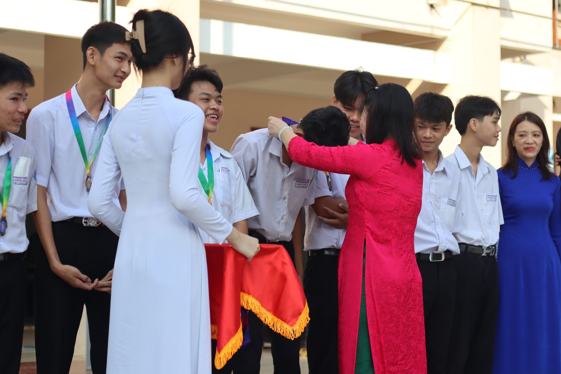 A music teacher congratulating a student and parent after a good exam result