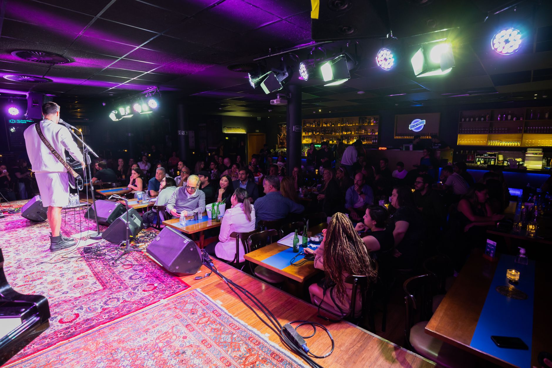 A small UK venue full of people watching a live band
