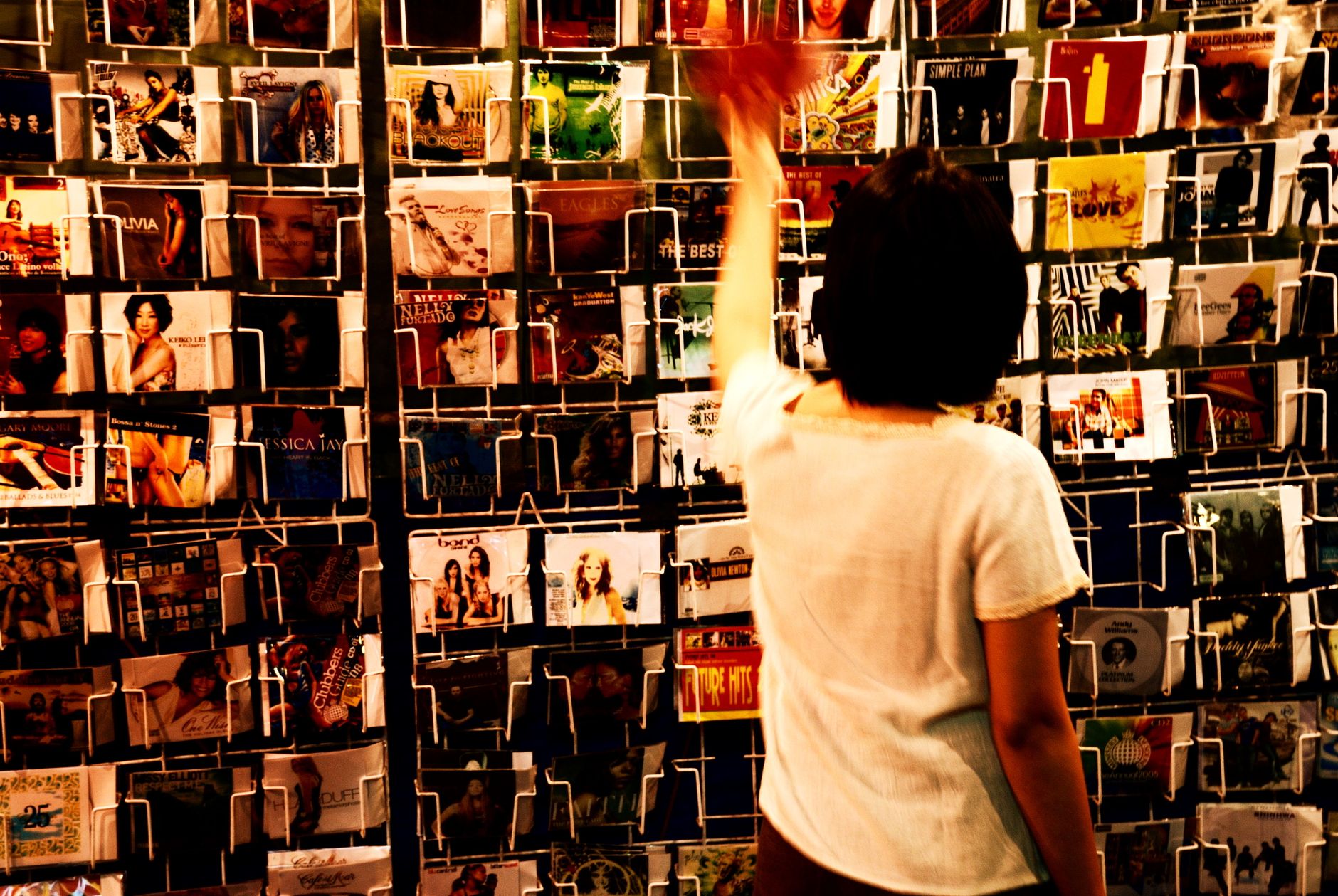 A musician talking to fans and collecting details at the merch table