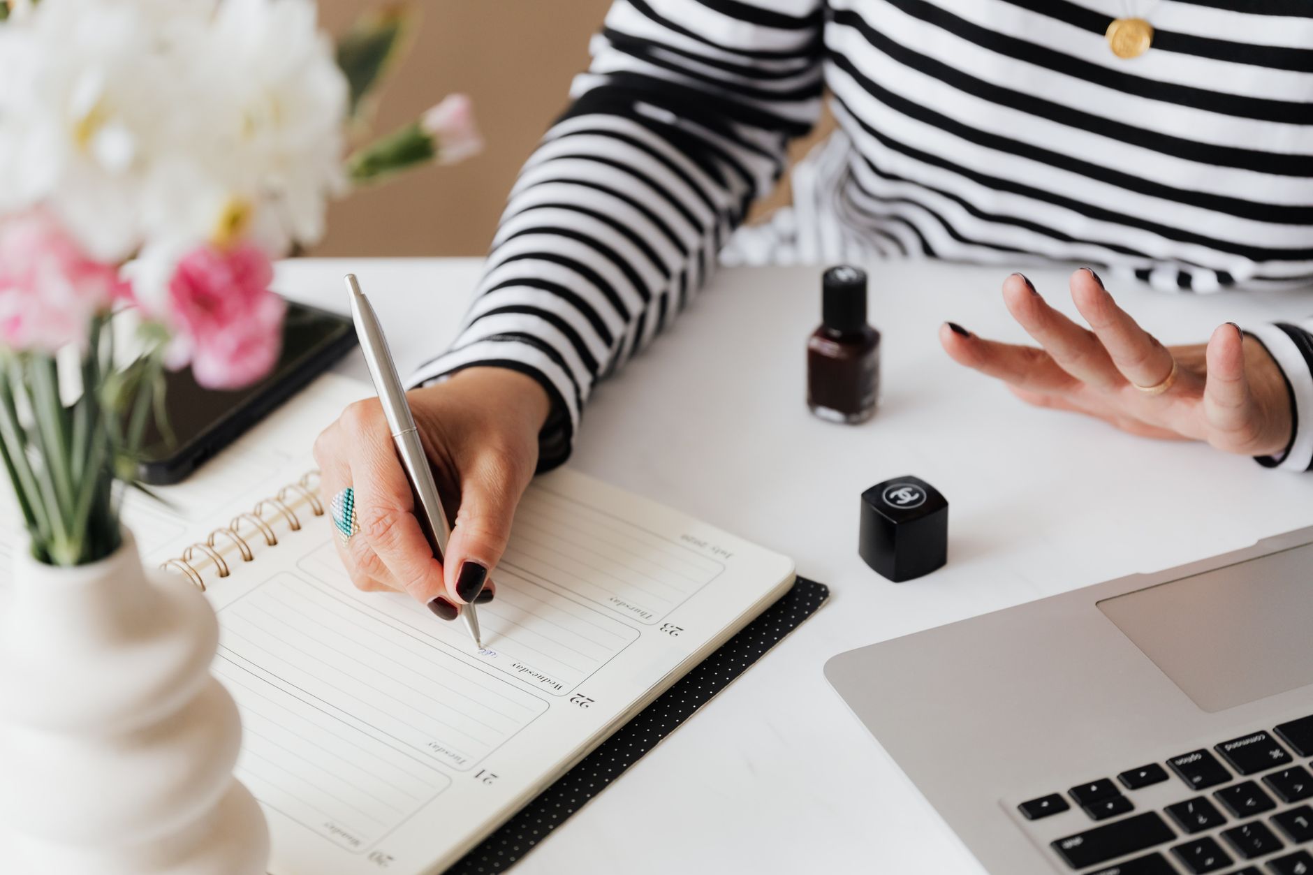 A nail technician checking her bookings and planning rebookings