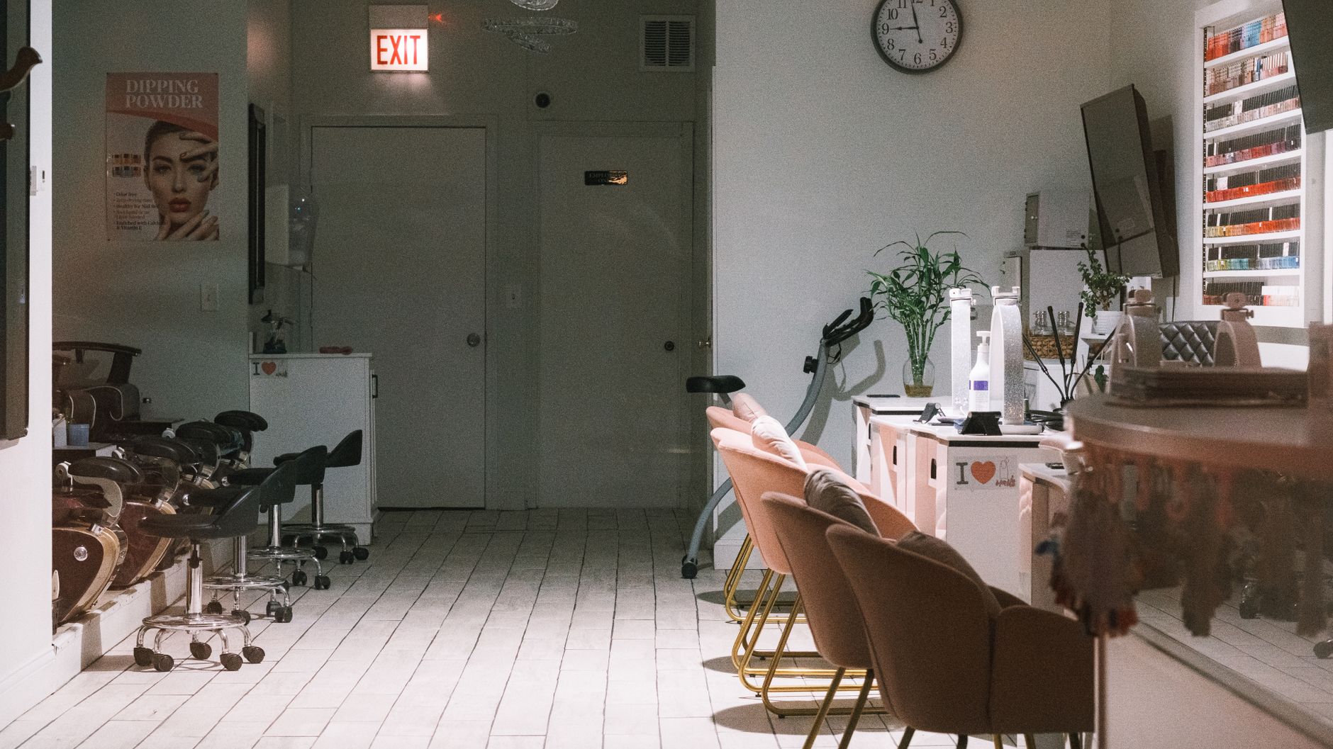 A nail technician reviewing a quiet appointment book