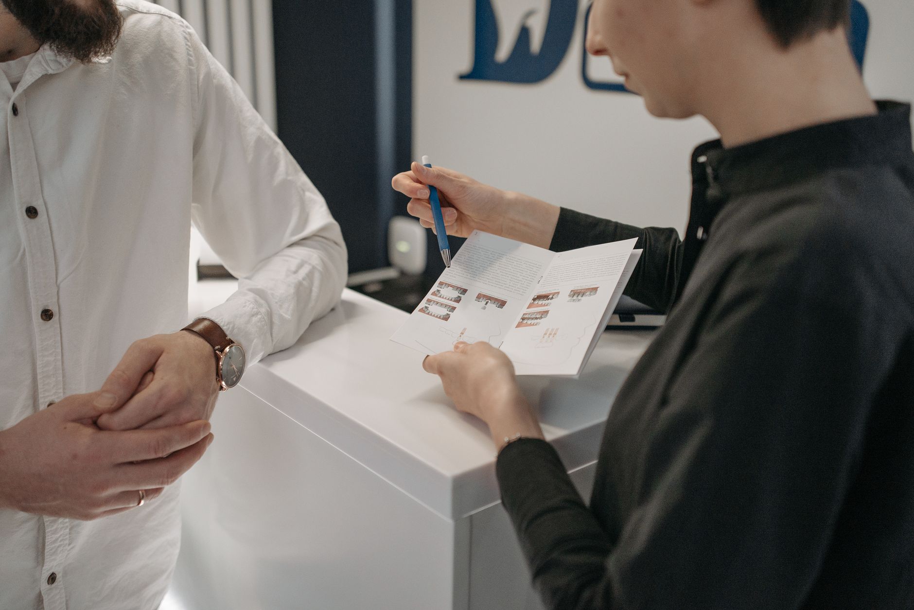 An optician recognising and greeting a returning patient