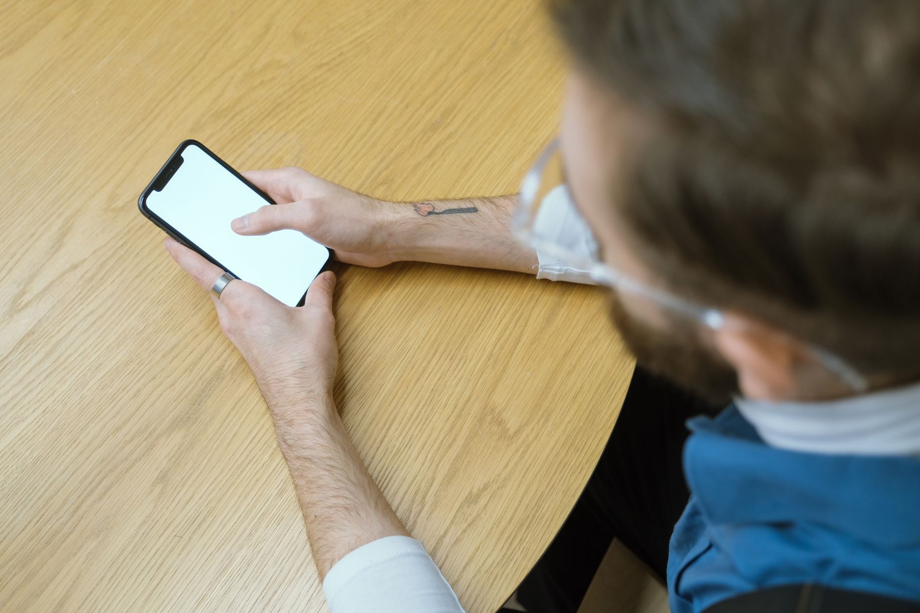An osteopath checking patient reviews and messages between appointments