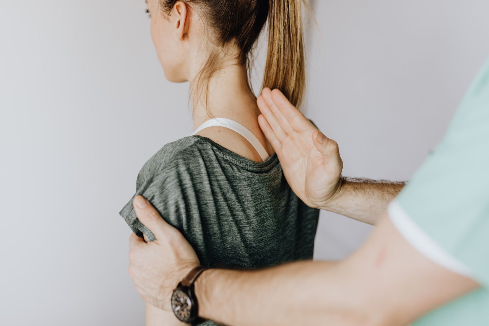 An osteopath giving a patient simple advice to take home