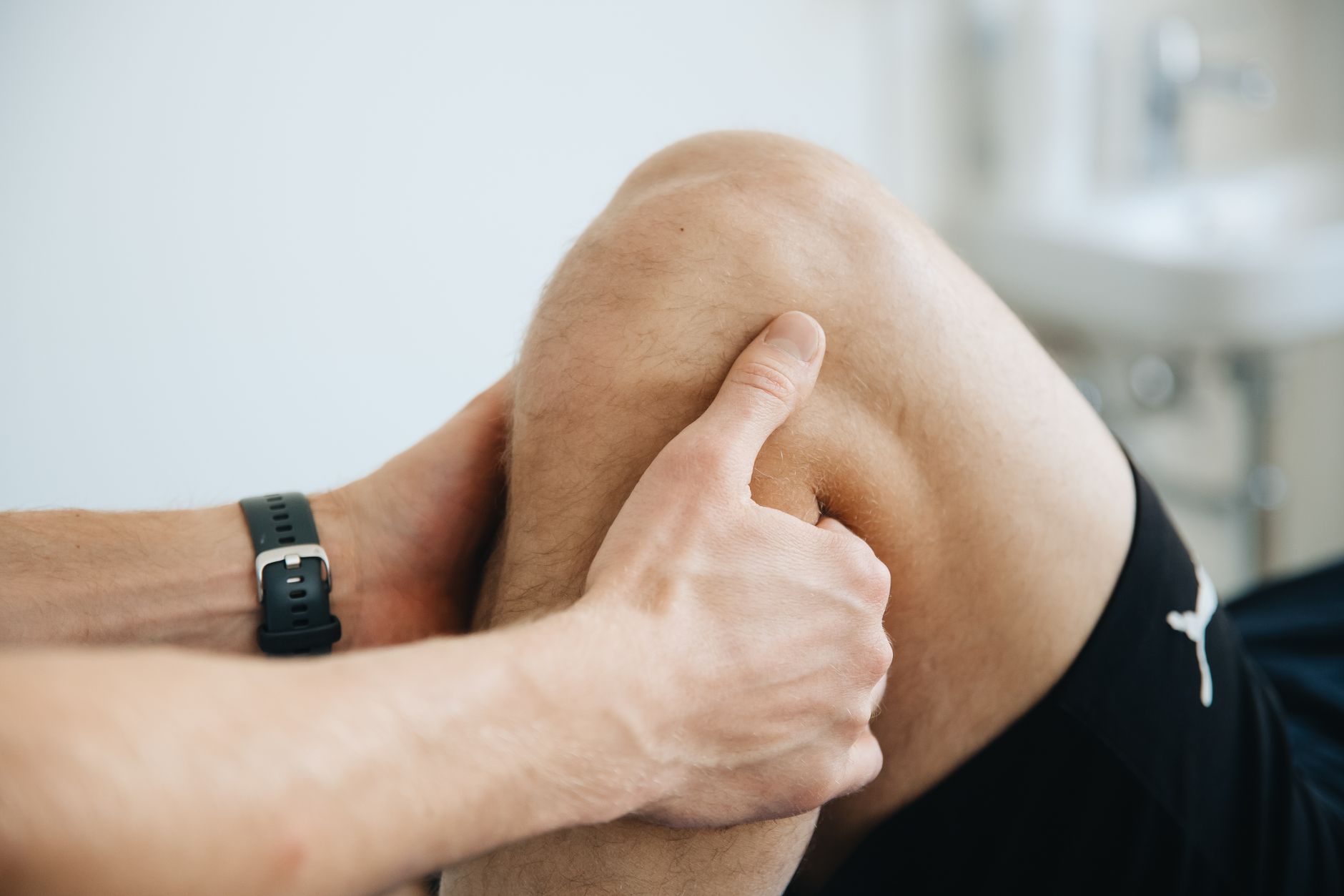 A physiotherapist assessing a runner's leg injury