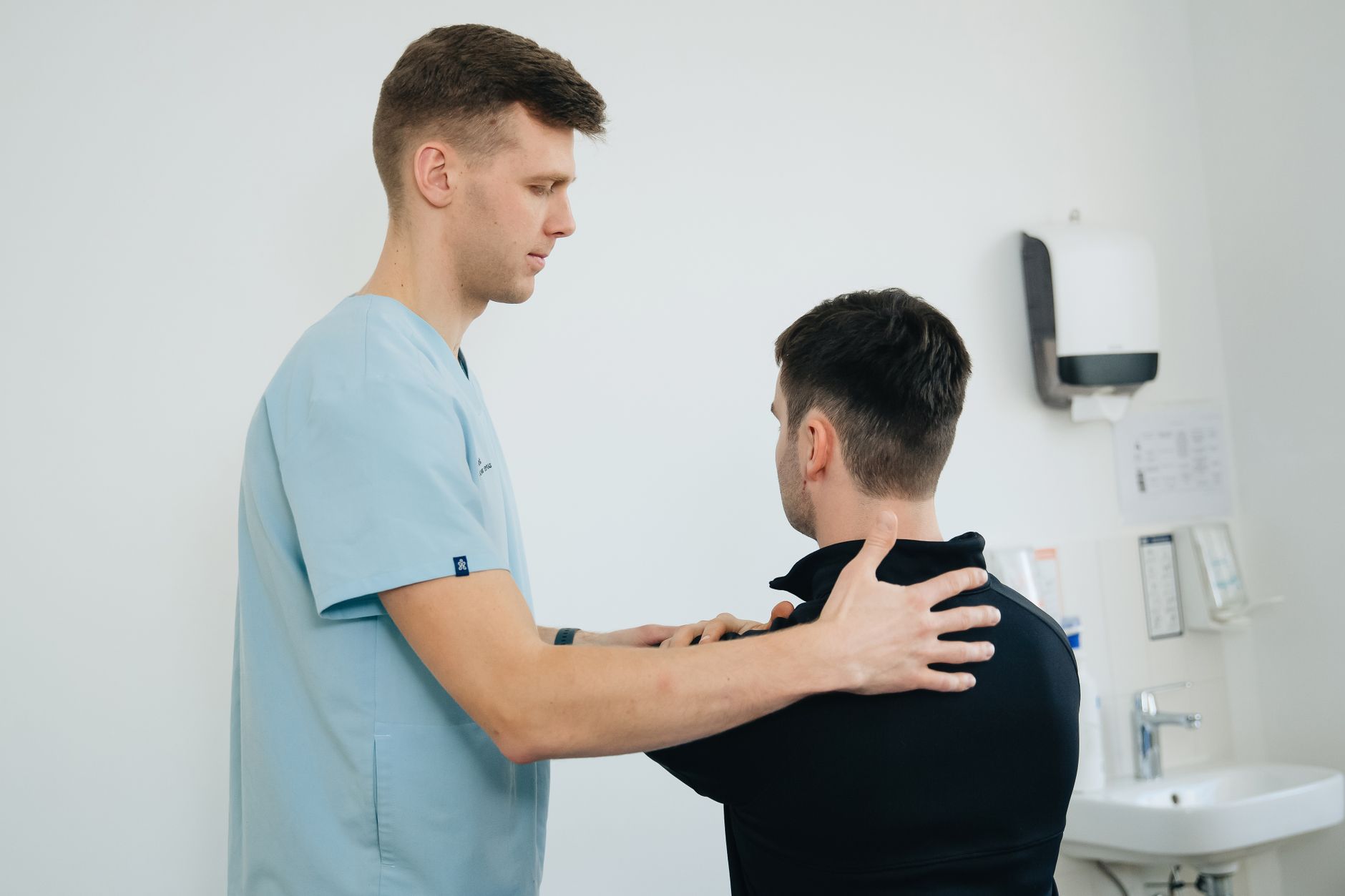 A physiotherapist working with a patient in a small private clinic