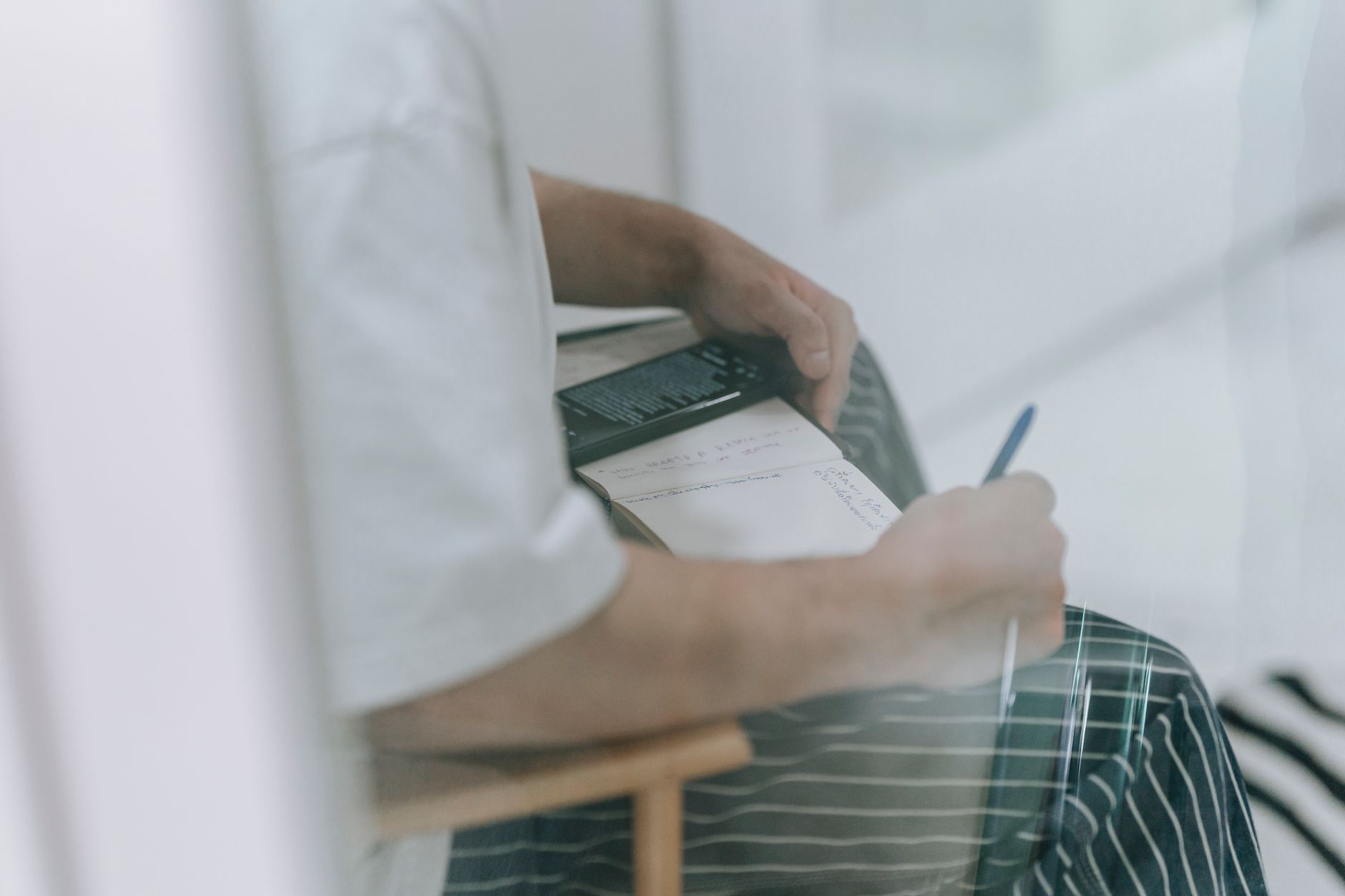 A plumber going through his weekly tasks with a notebook and phone