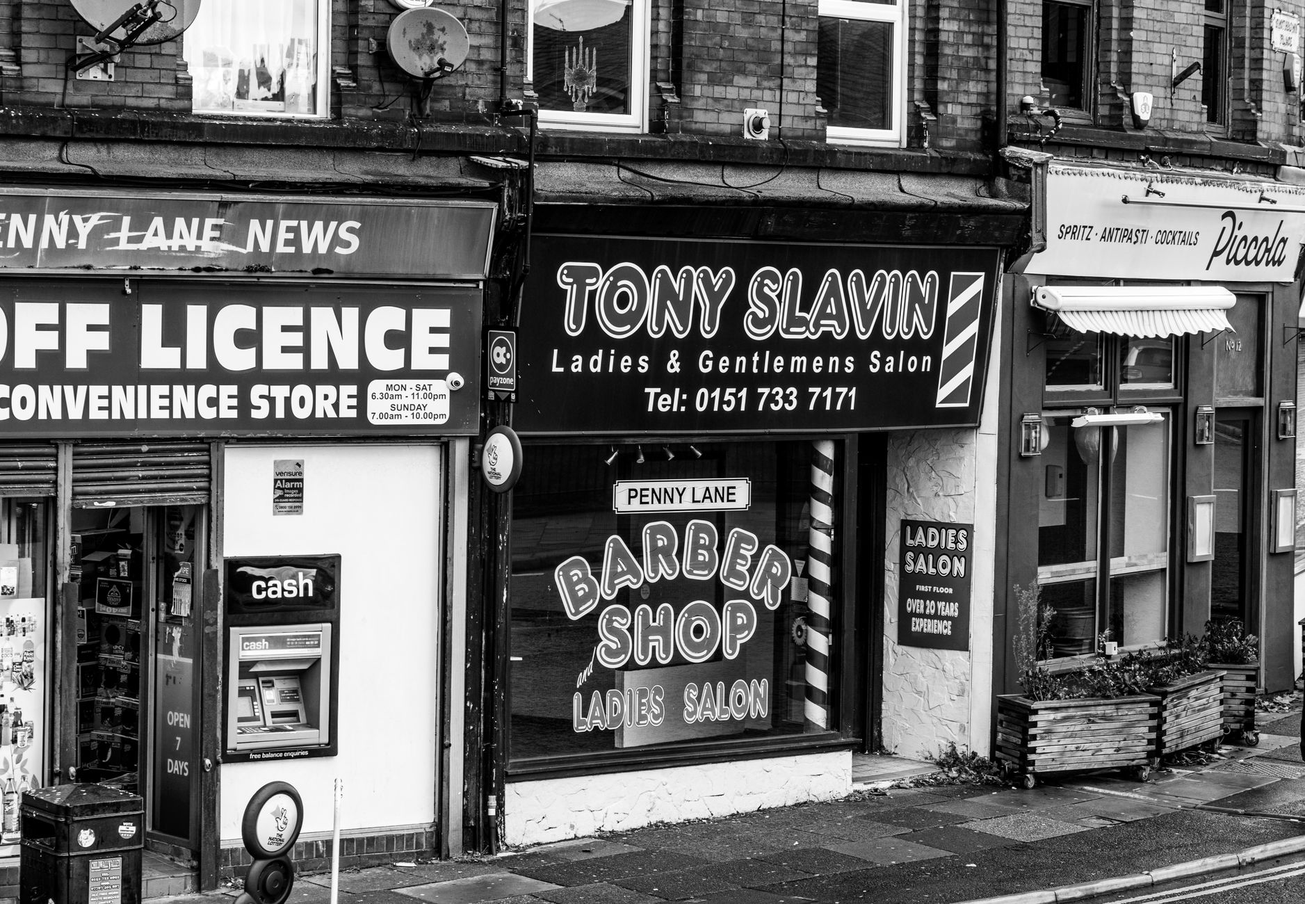 An independent beauty salon storefront among other small shops